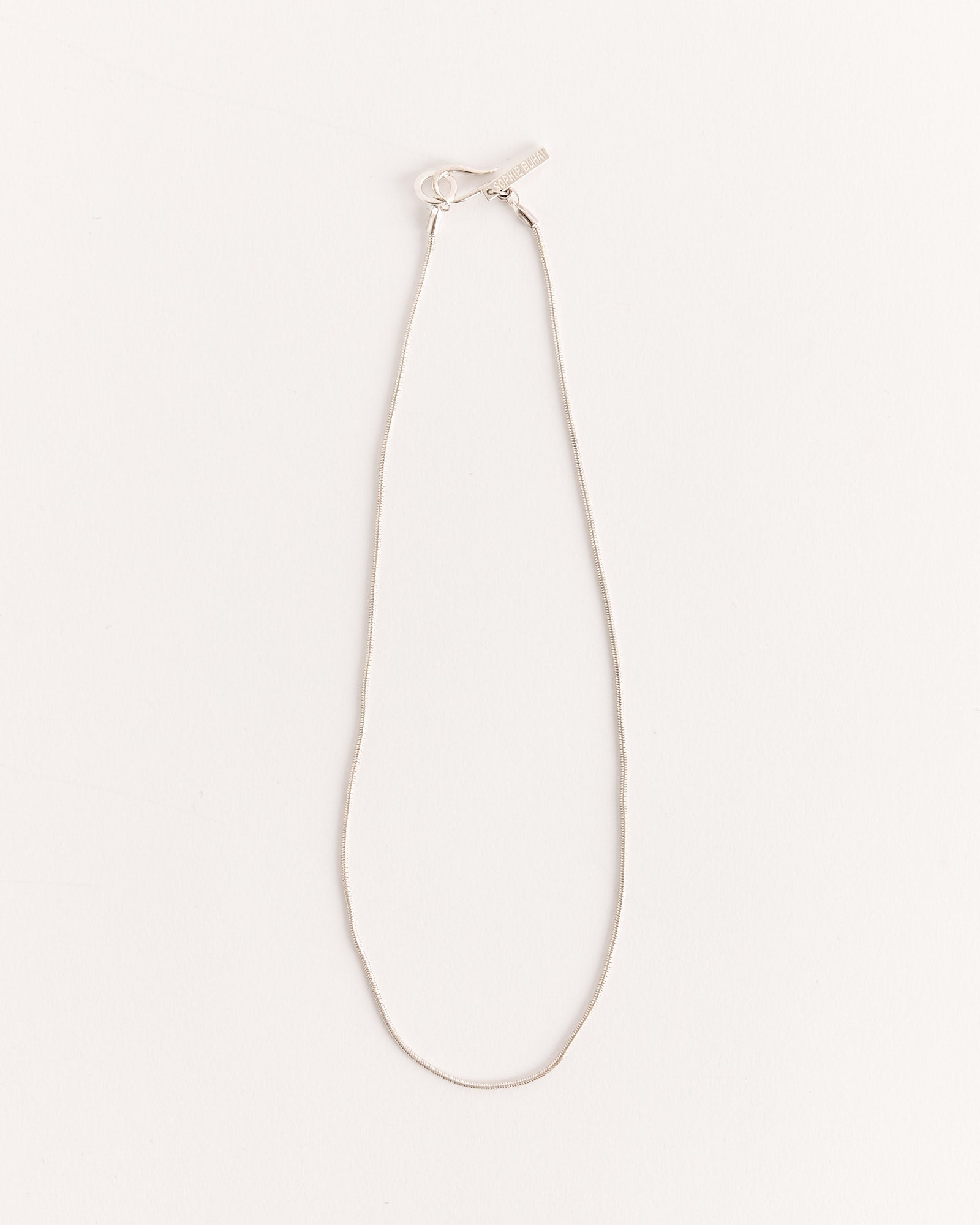 The Sophie Buhai Diana Necklace in Sterling Silver, featuring a slim chain and minimalist clasp, is displayed in an oval shape on a plain white background.