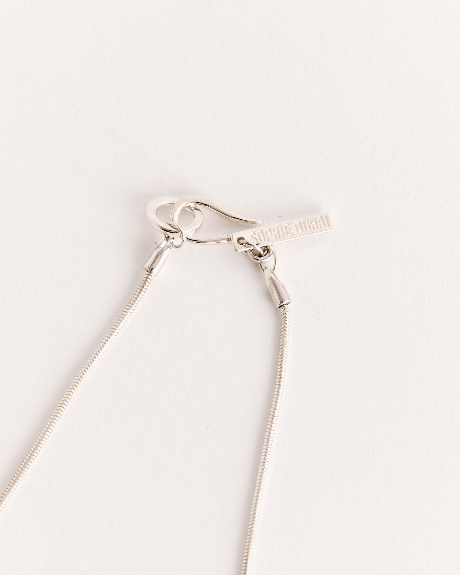 Close-up of the Diana Necklace in Sterling Silver by Sophie Buhai, featuring a clasp with a small rectangular tag engraved with the brand name, handcrafted in Los Angeles, shown against a plain white background.