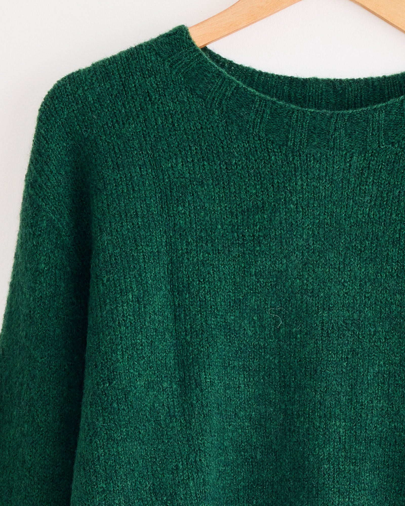 A Mijeong Park Alpaca Blend Wholegarment Knit in green, displayed on a swinger.