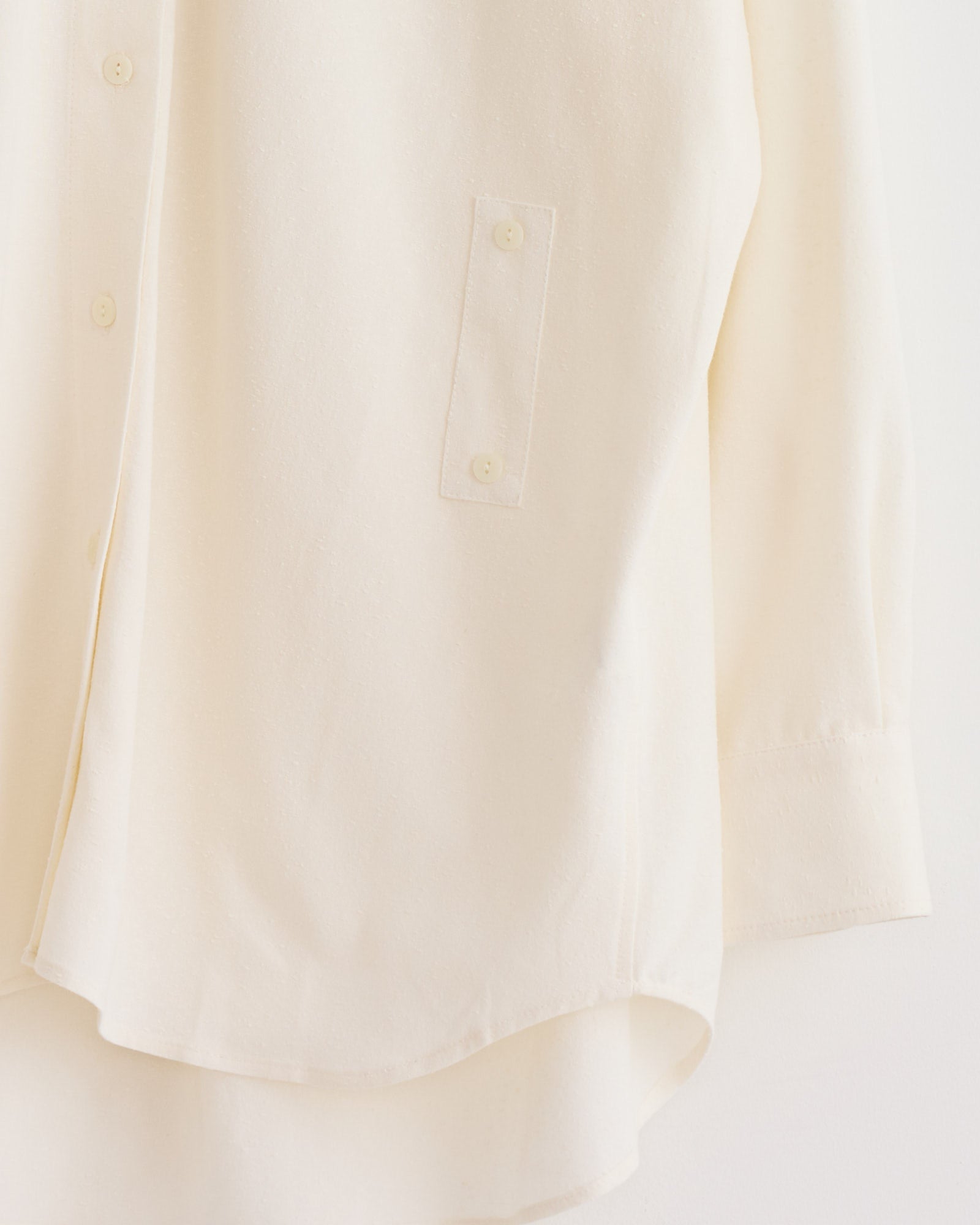 A close-up of the Mijeong Park Textured Oversized Shirt in Ivory highlights its versatile fit and cotton-blend texture.
