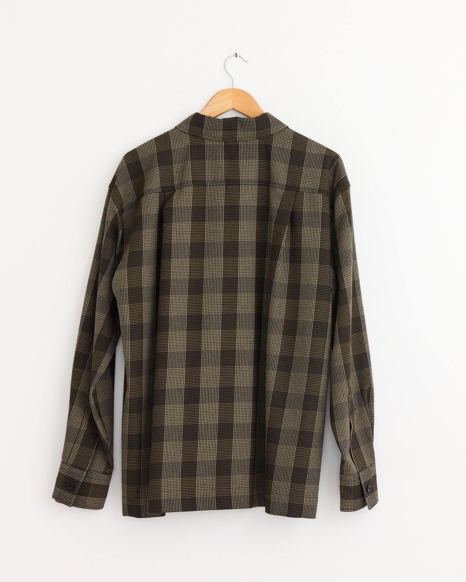 The Margaret Howell Flap Pocket Overshirt in Black/Brown/Multi, made from cotton wool twill, delivers a relaxed fit and timeless plaid style.