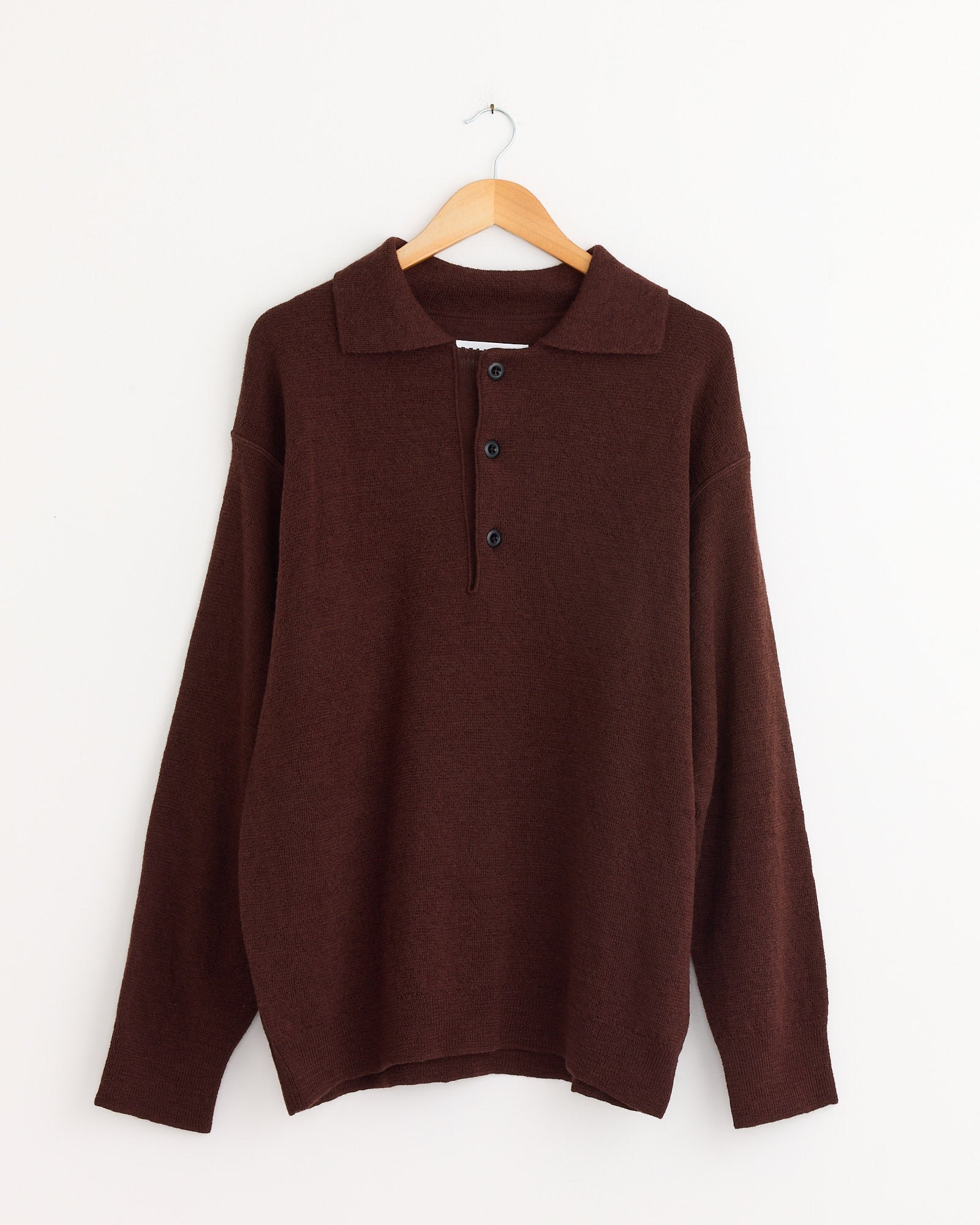 The MHL by Margaret Howell Oversized Knitted Polo in Dark Brown is ideal for chilly days. Need help with sizing or fit? Connect with our online chat for personalized assistance.