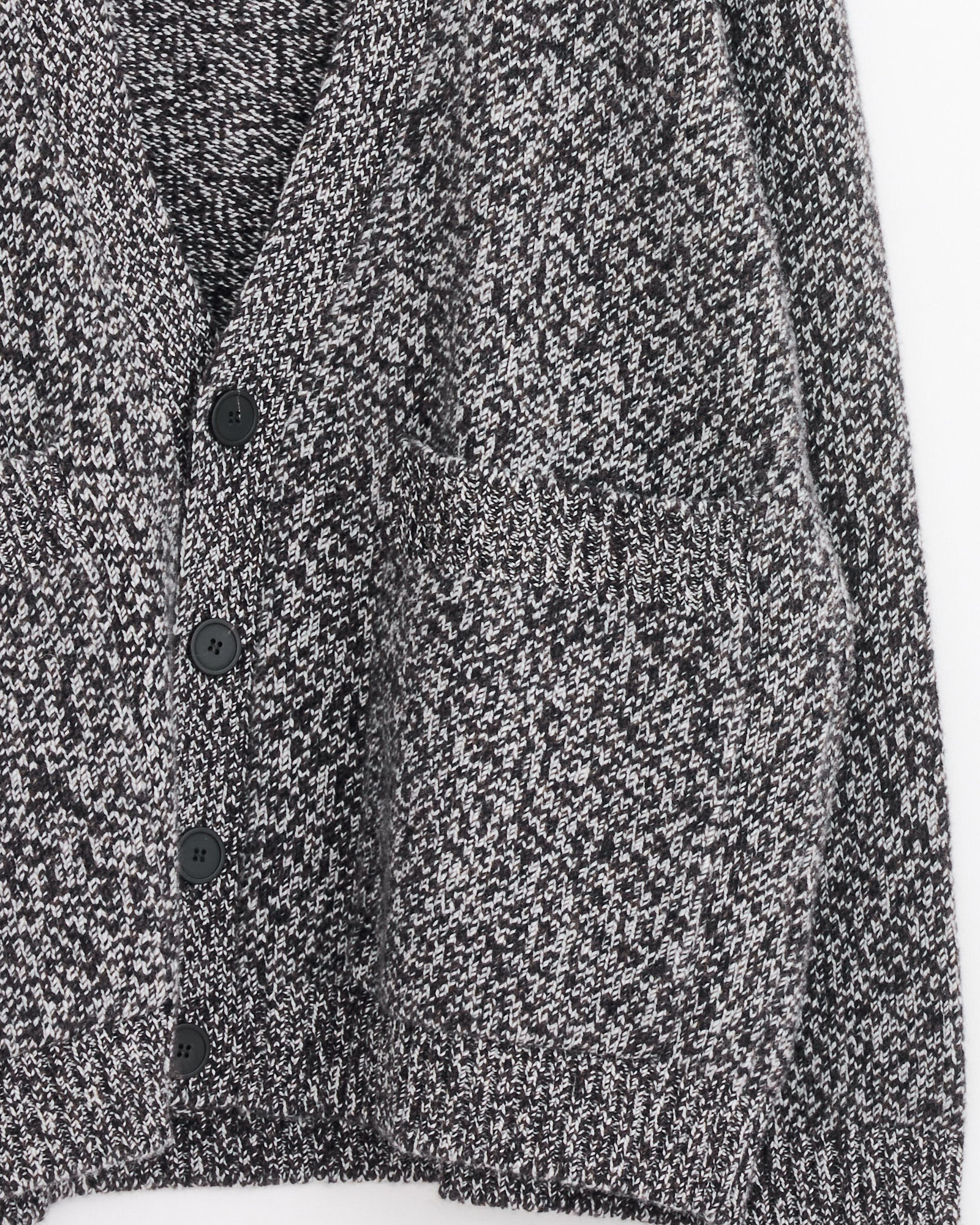 Close-up of Studio Nicholson’s Sen Cardigan in Navy Mouline, a heavyweight knit with black buttons and two pockets. The speckled navy fabric has a textured look, reminiscent of English lambswool, across the sleeves and body.
