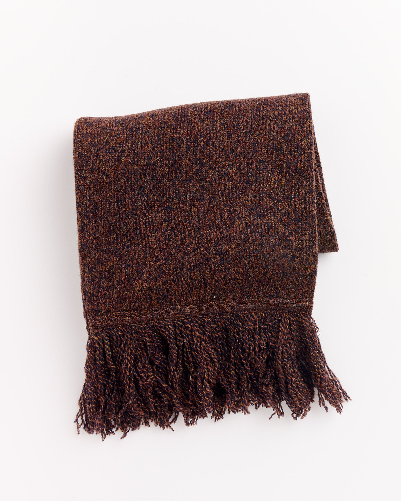 The Still By Hand 7G Fringe Muffer in Melange Brown, a folded woven scarf with fringed ends, is shown on a white background.
