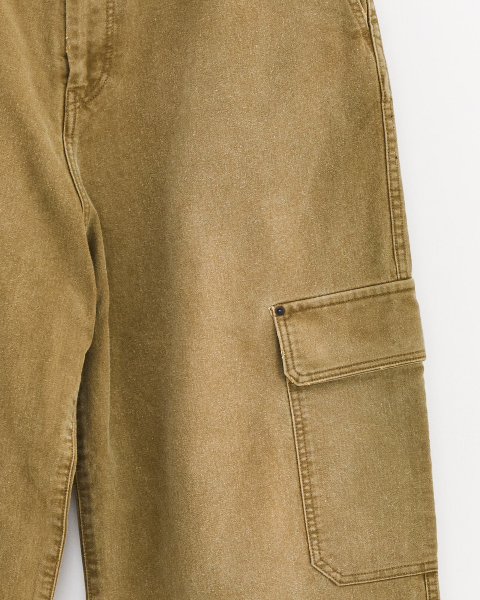 Close-up of the ssstein Sulfur Dyed Trousers in Khaki, featuring whipcord fabric and a side flap pocket with a metal snap button, shown against a plain white background.