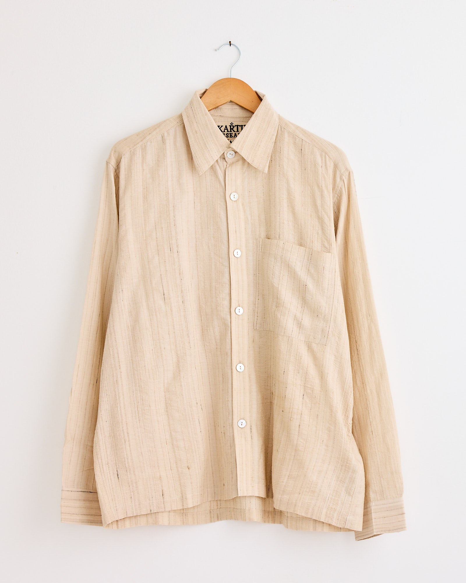 A stylish swinger wears the Kartik Research Pataudi Shirt in Peach/Gold—a handwoven silk piece that exudes elegance and effortless charm.