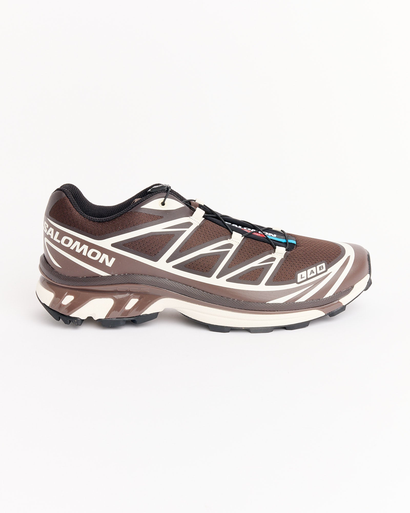 The Salomon XT-6 in Coffee/Roast/Vanilla features a brown and white colorway with black laces and a rugged sole, displayed in side profile against a plain white background.