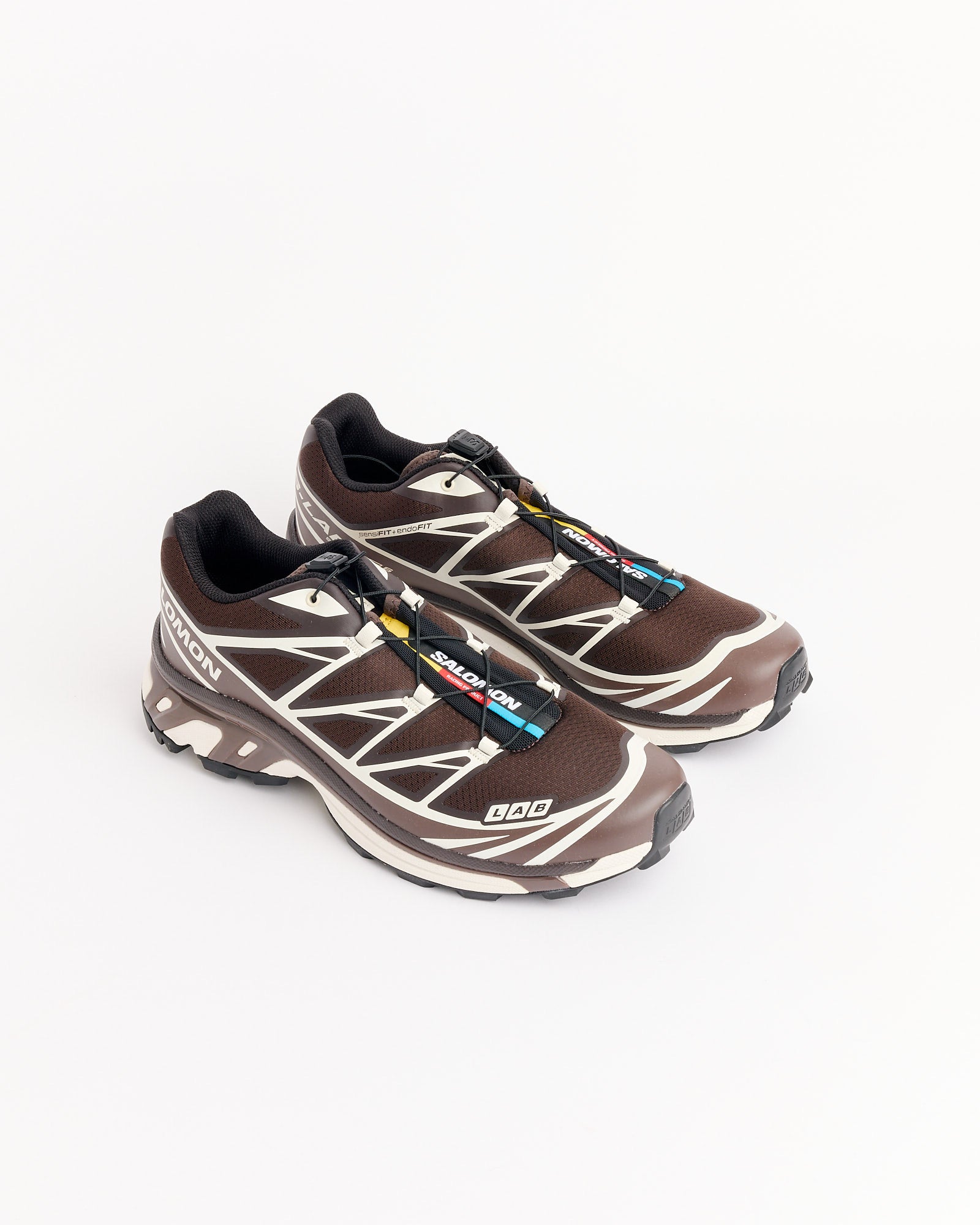 A pair of Salomon XT-6 trail running shoes in Coffee/Roast/Vanilla with black laces and rugged soles, displayed on a plain white background.