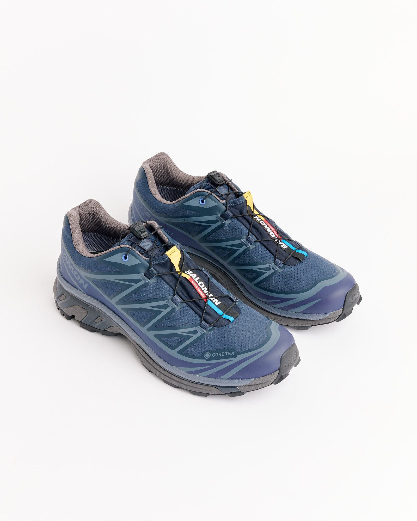 The Salomon XT-6 GTX trail running shoes in Blue Nights/Astral/Pkiten feature black soles, a quick-lace system, GORE-TEX and Sensifit labels, and are displayed on a white background.