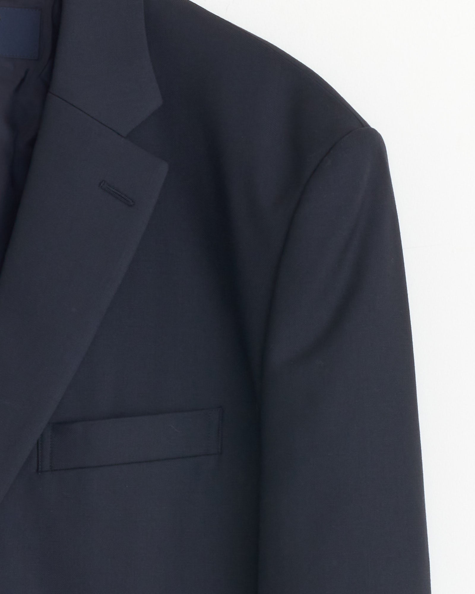 A close-up of the upper section of the Comme Des Garçons Homme Single-Breasted Jacket in Navy on a white background, highlighting the lapel, shoulder, and chest pocket.