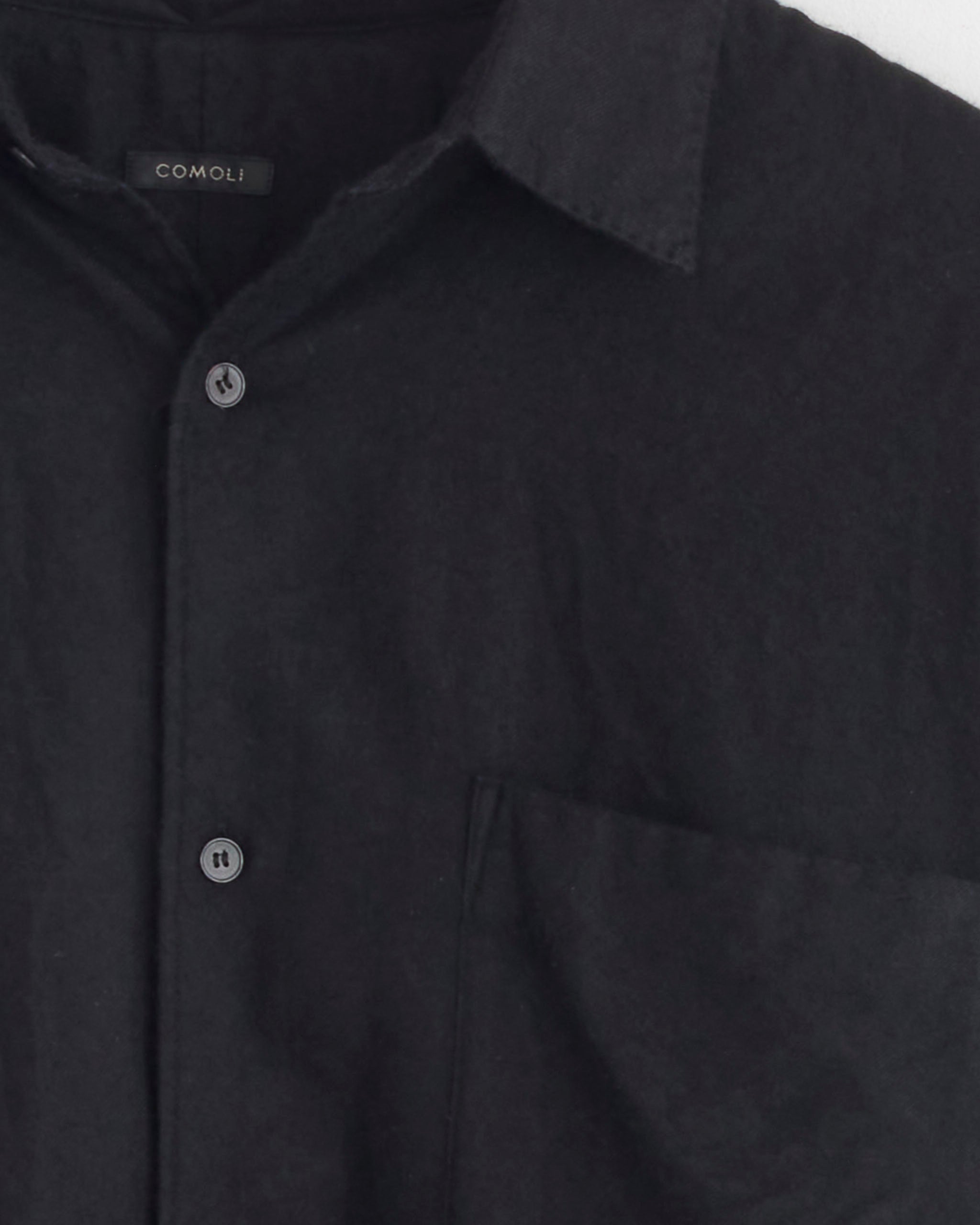 Close-up of the Comoli Cashmere Silk Garment Dyed Shirt in Navy, featuring a collar, chest pocket, and visible Comoli label. Only the upper half is shown against a white background.