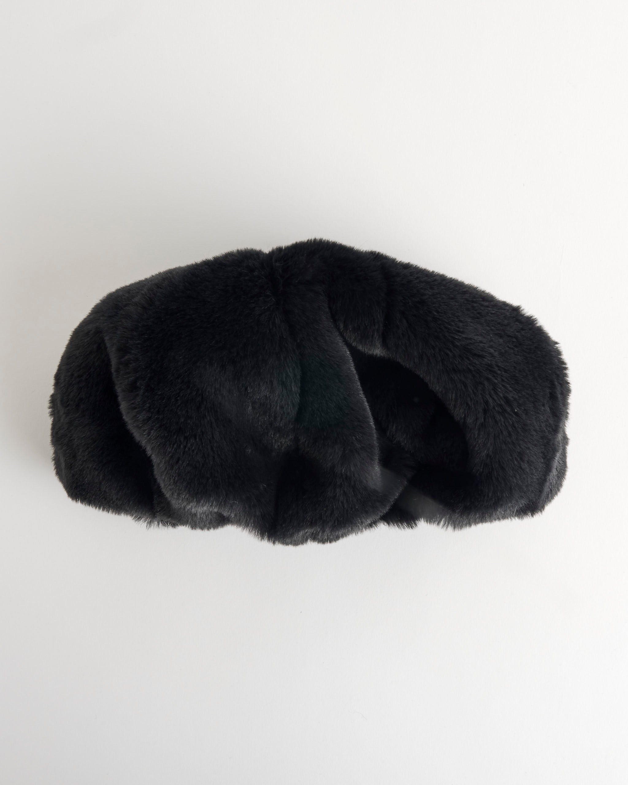 The Clyde Faux Fur Beret in Black features a soft, plush texture and is photographed against a plain white background.