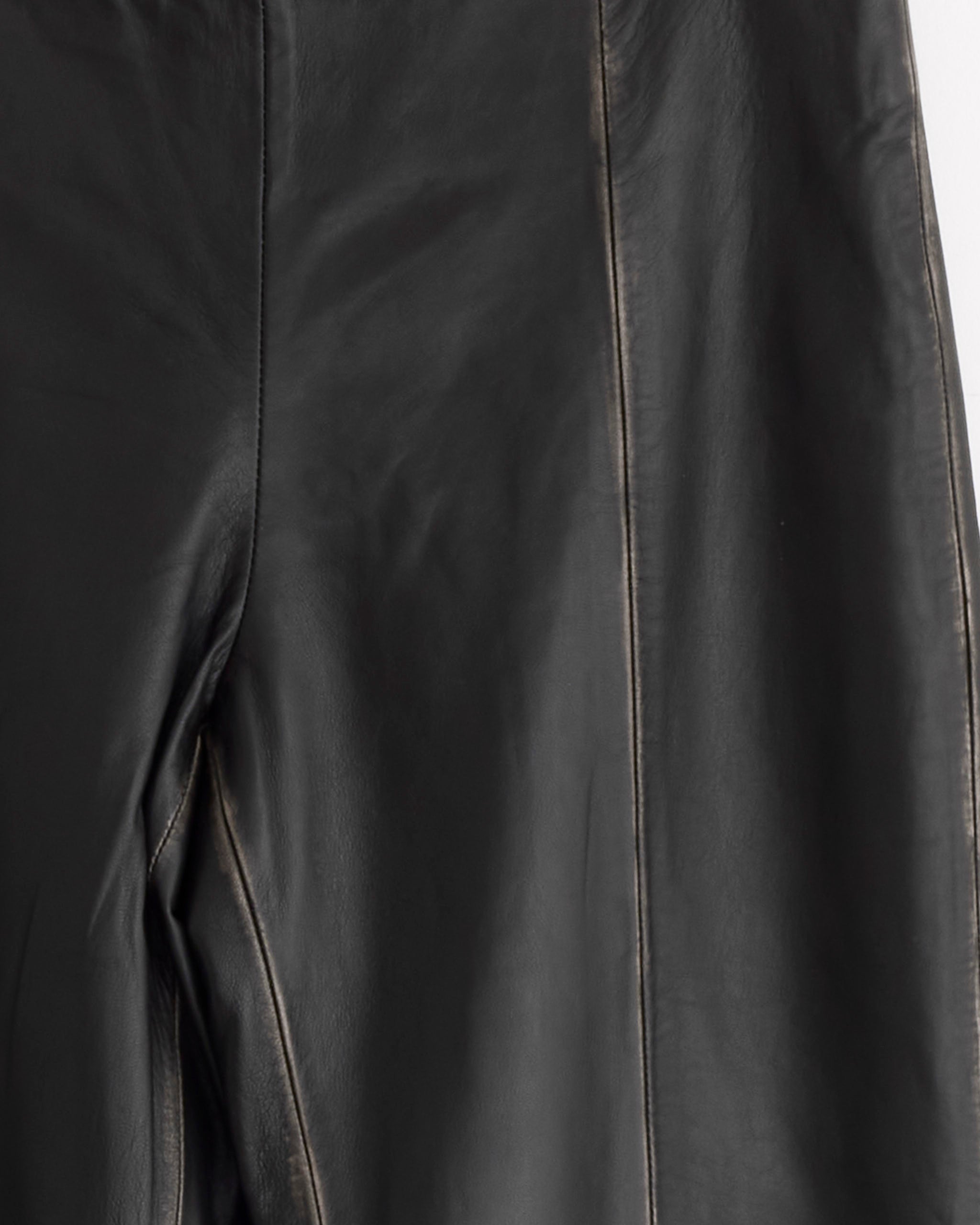Close-up of the ST. AGNI Brushed Leather Pant in Black featuring visible seams and a smooth, slightly shiny lambskin texture.