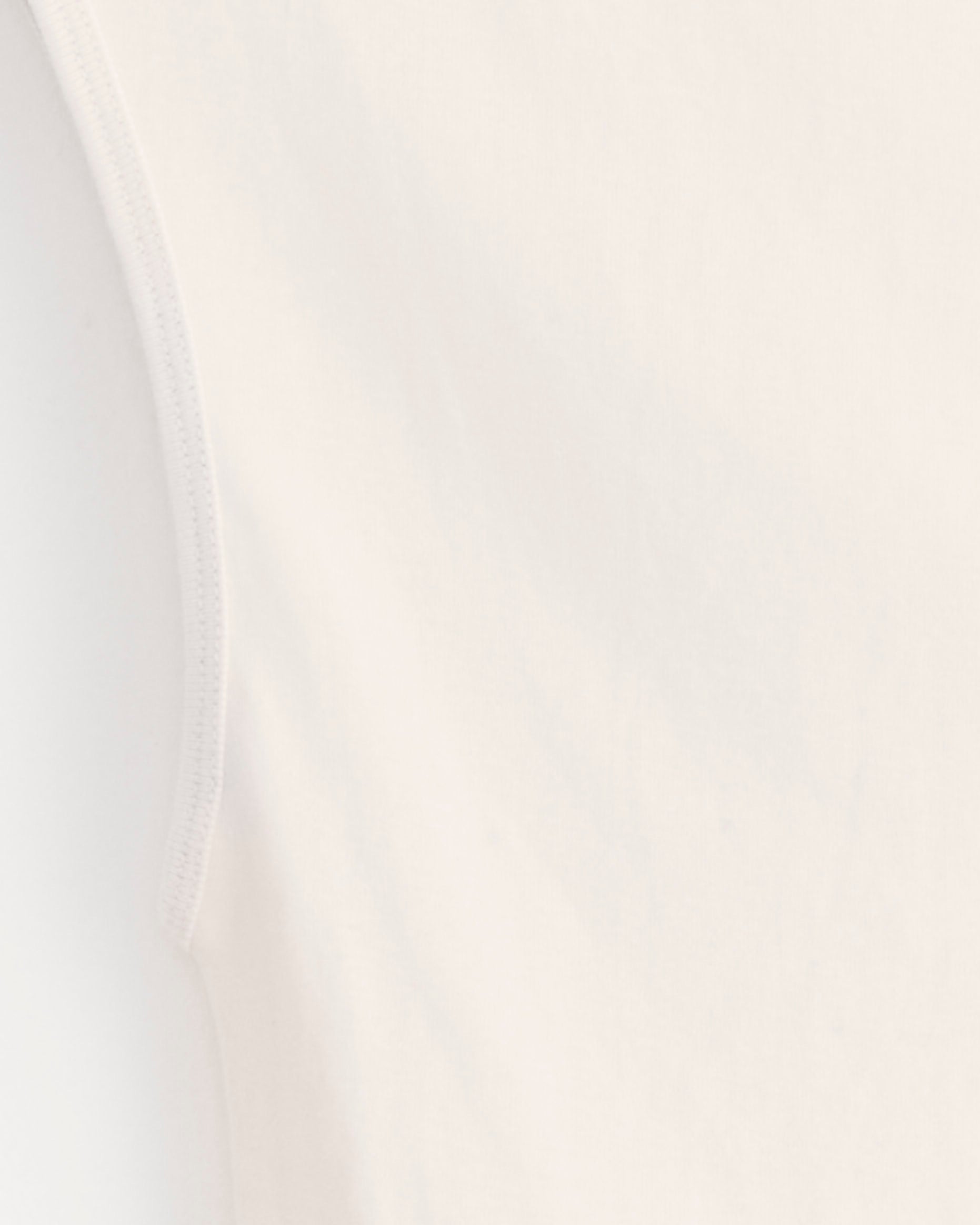 Close-up of the upper side of the ST. AGNI Ballerina Top in Shell Pink, made from light organic cotton, highlighting the smooth fabric texture and armhole seam.