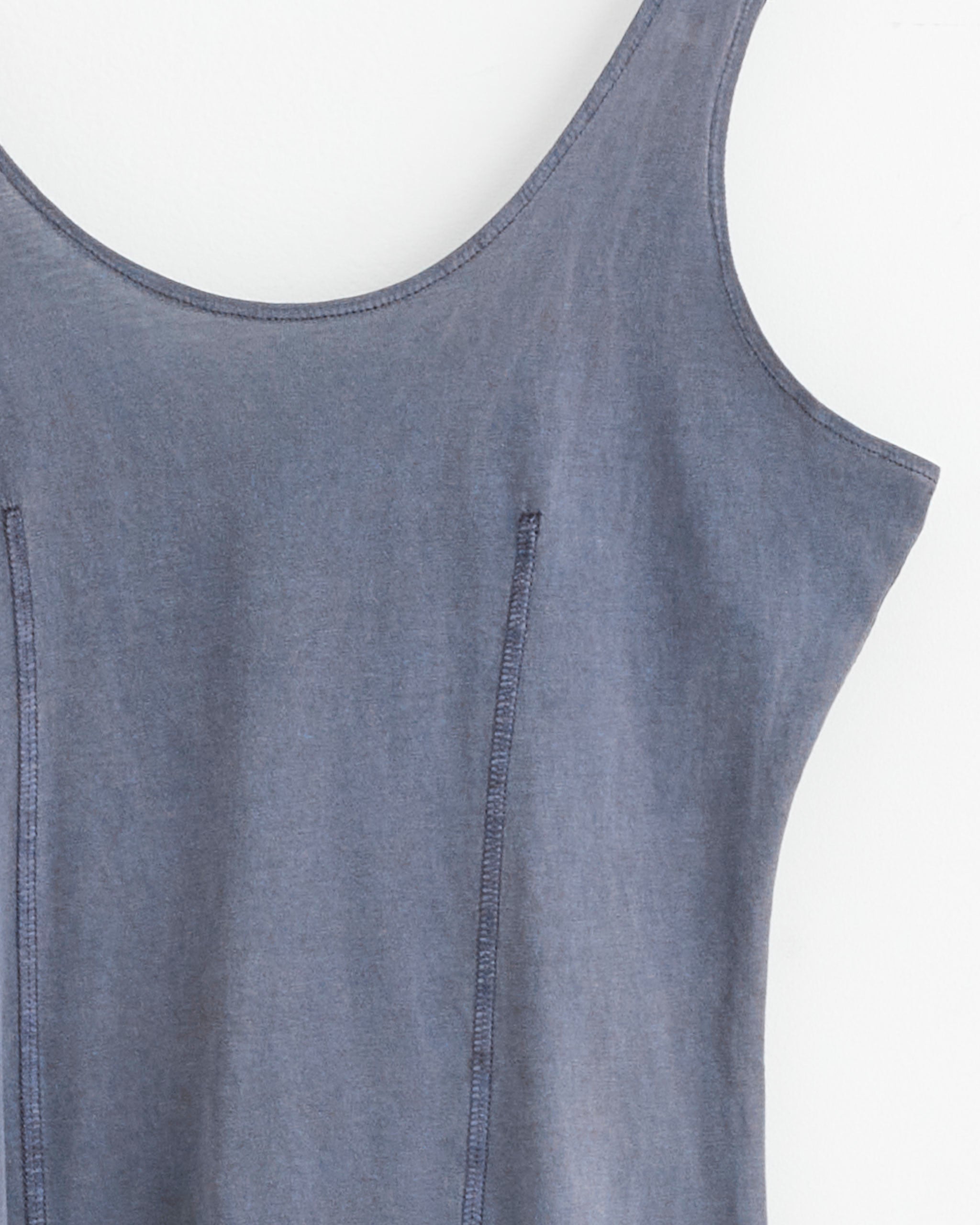 A close-up of the upper part of the sleeveless Blade Dress in Antique Amethyst by Our Legacy, featuring visible seam lines and a scoop neckline, crafted from organic cotton and set against a plain white background.