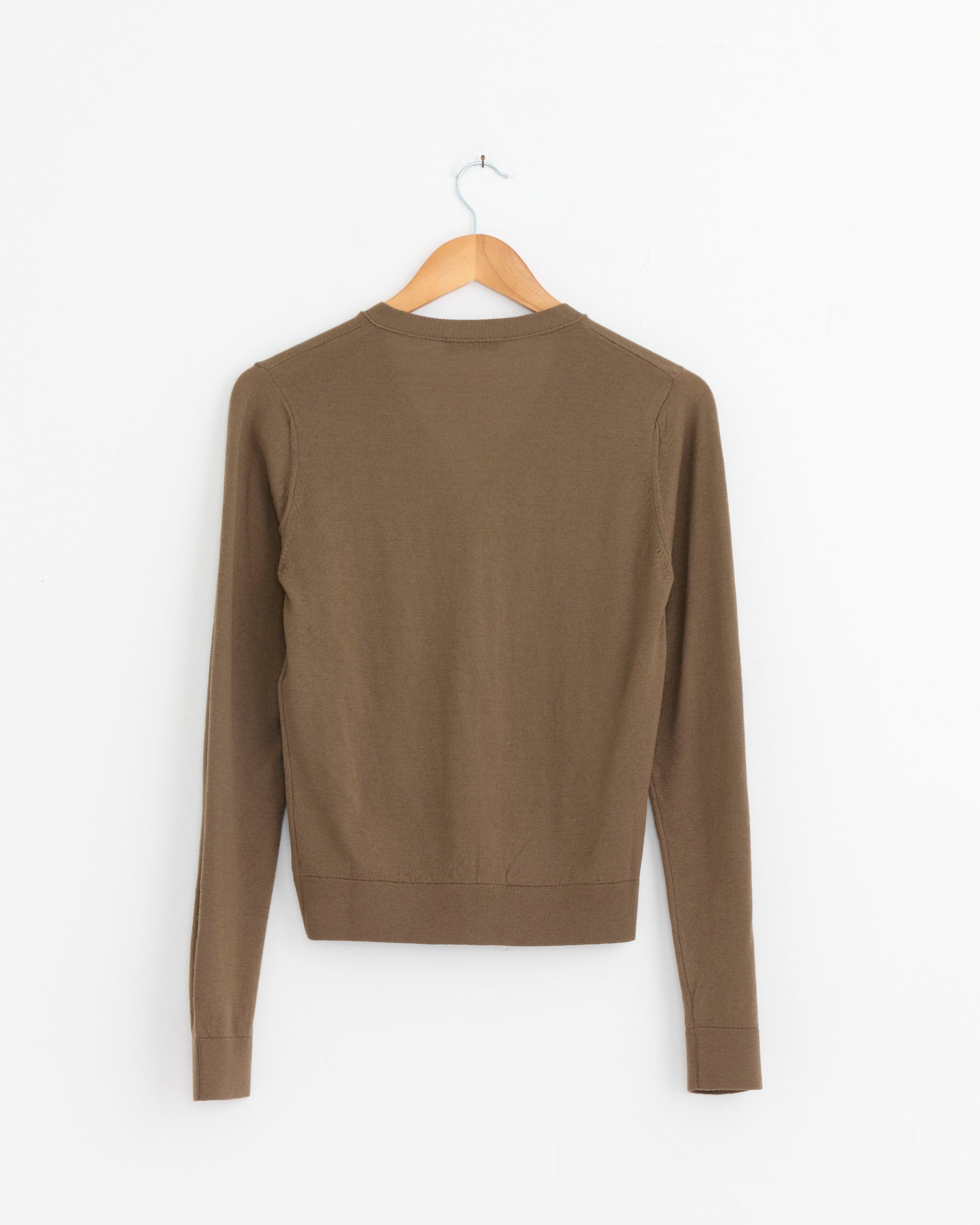 A Lemaire V Neck Buttoned Cardigan in Mushroom is displayed on a wooden hanger against a white background, shown from the back.