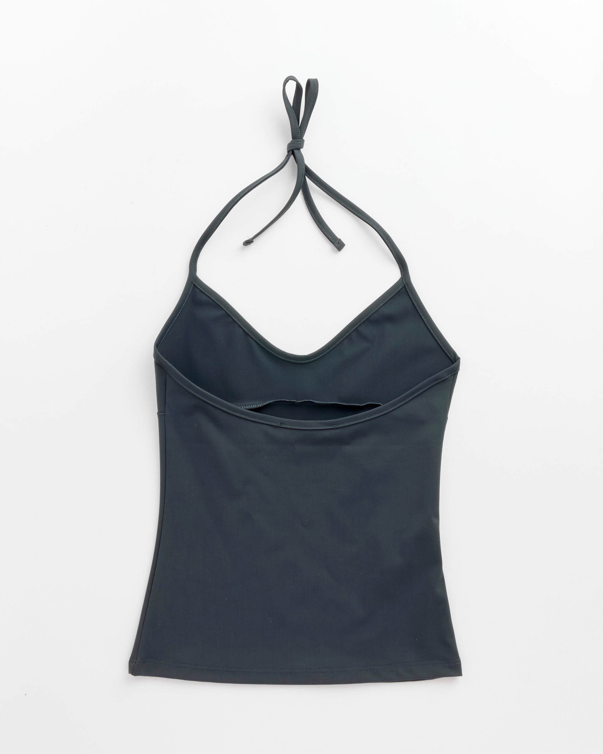 The Lula Top in Grey by Gimaguas is a dark gray microfiber fitted top with a sleeveless halter design, v-shaped neckline, small front cutout, and adjustable strap, shown laid flat on a white background.