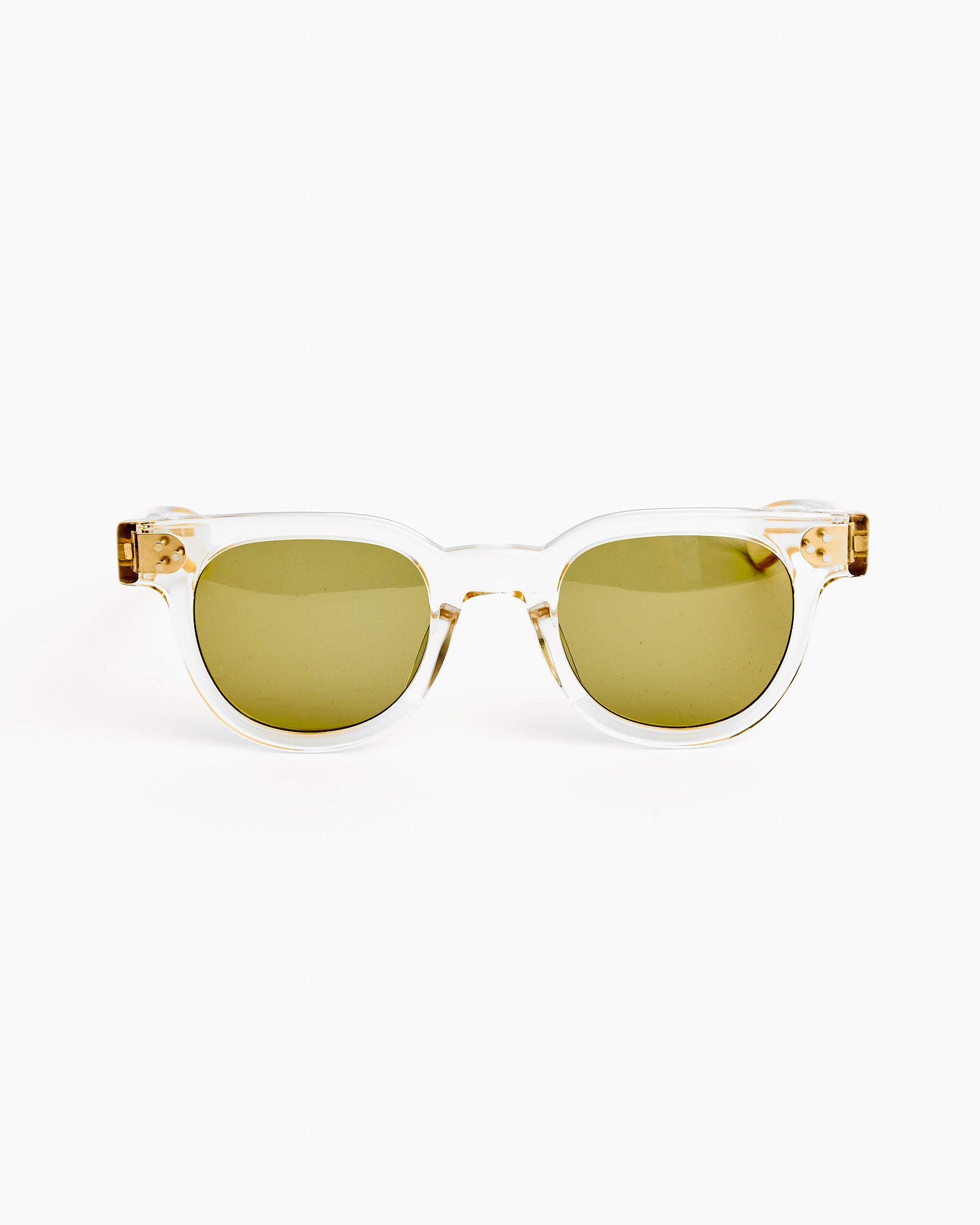 The Frankie Sunglasses in Champagne/Mid Green by Shady Character feature clear frames and green lenses, shown front-facing on a white background. For sizing or fit questions, our online chat can help you find your perfect pair.