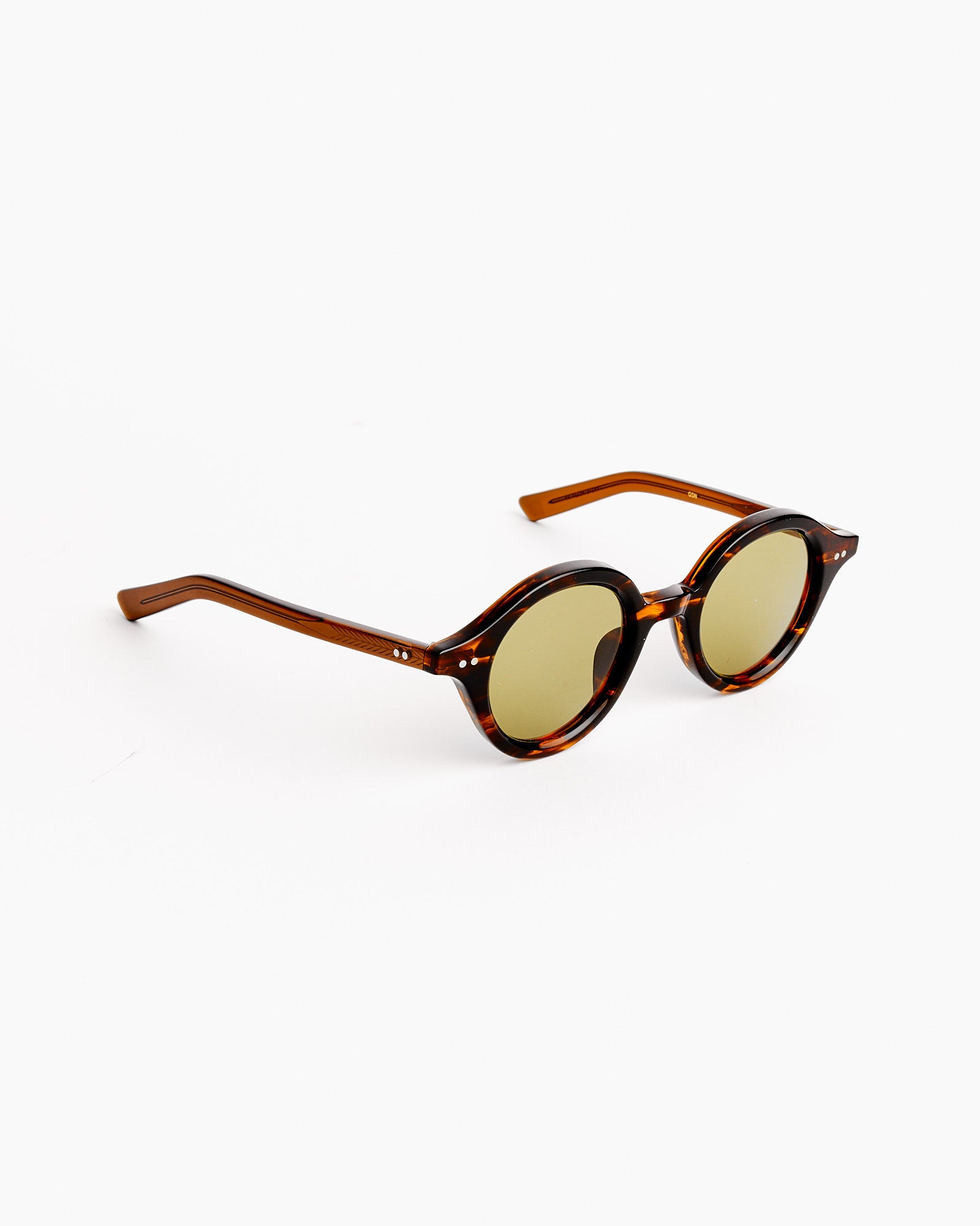 Native Sons Harper 2.0 Sunglasses in Gasoline/GN-30 Green feature round tortoiseshell Japanese acetate frames with green-tinted lenses, displayed at an angle on a white background.