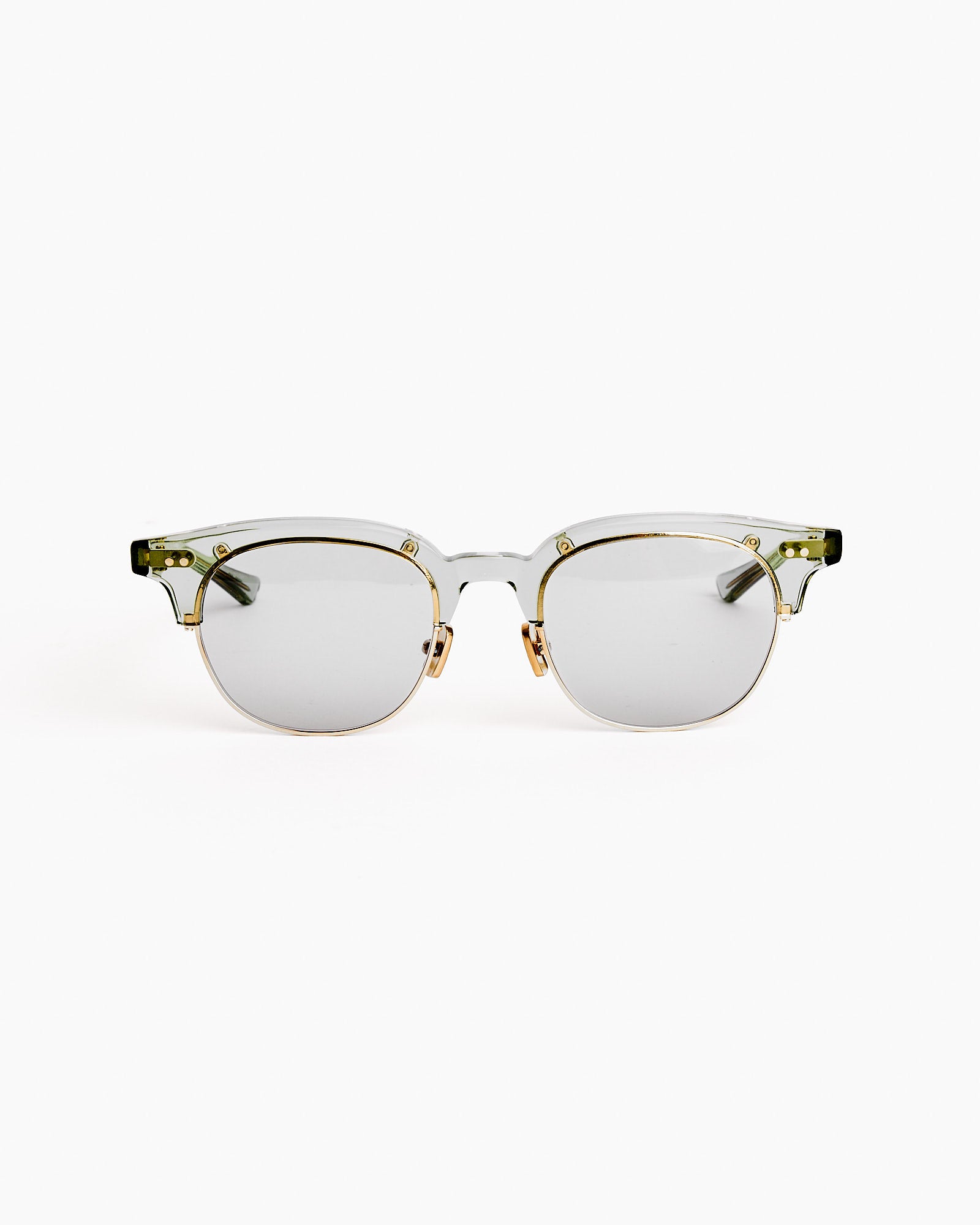 The Native Sons Guerrero CMB49 Sunglasses in Bottle Green/16K Gold/GR-56 Light Grey showcase a transparent gold frame, bottle green accents, and round light grey lenses—expertly crafted in Japan and shown on a white background.
