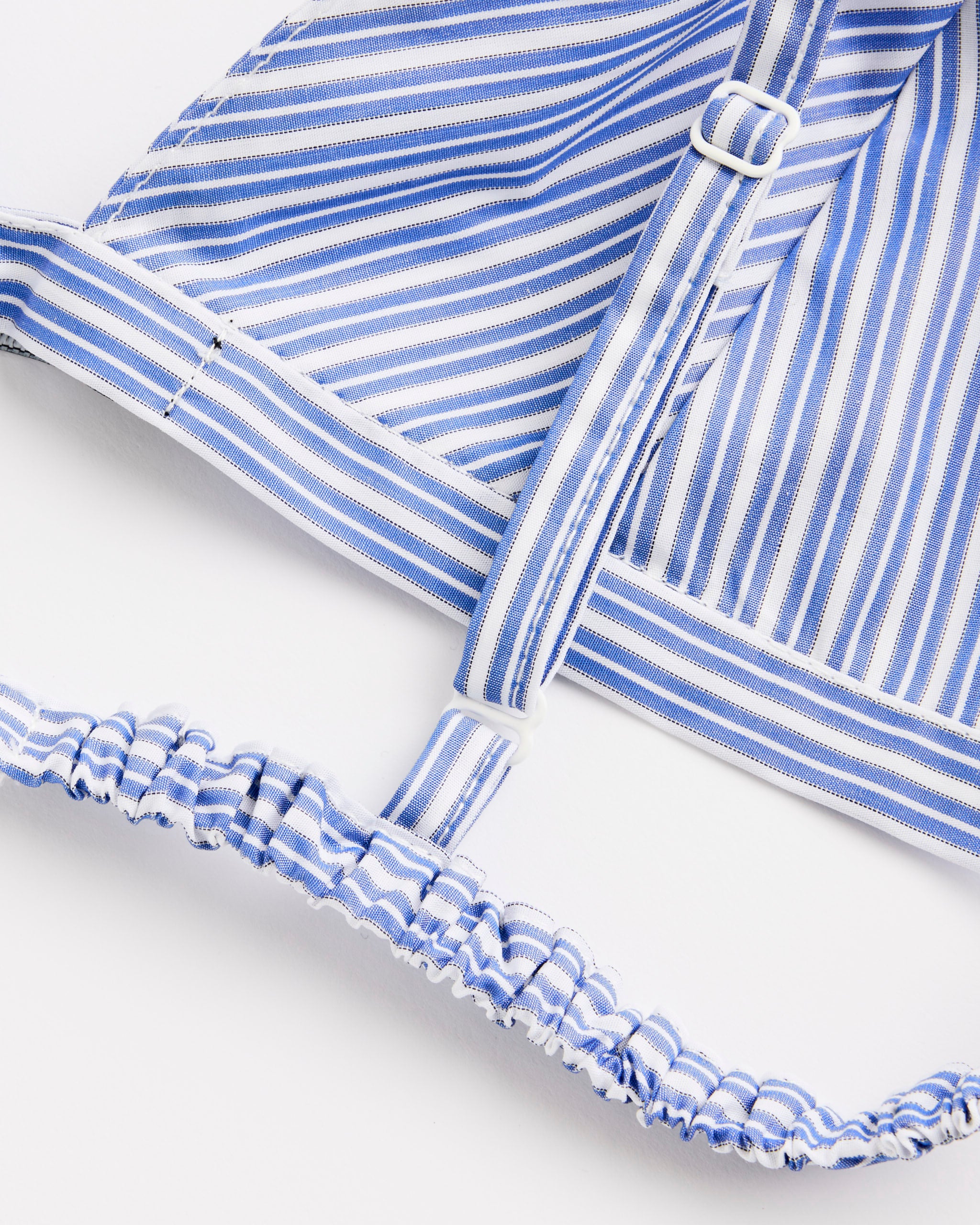 Close-up of the Hommegirls Shirting Bralette in Blue Mini Stripe, featuring adjustable straps and an elastic band, displayed against a white background.