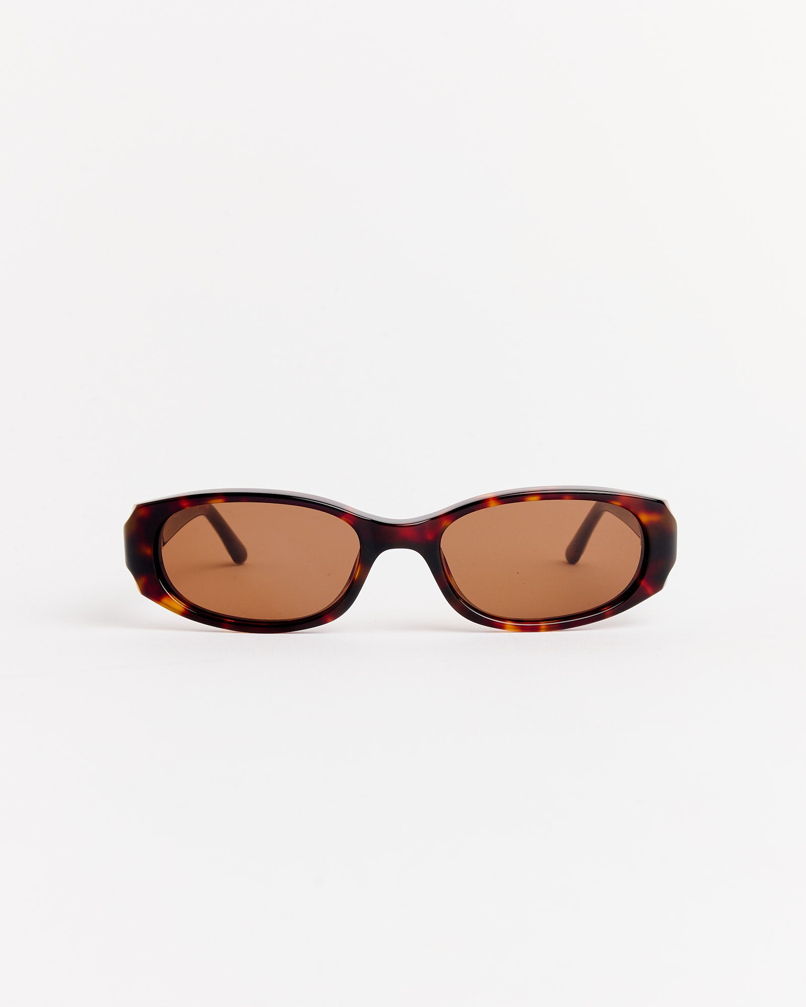 Chimi Note Sunglasses in Tortoise, featuring a brown oval frame, are displayed on a plain white background facing forward with both arms visible. For fit or sizing questions, contact us via online chat.