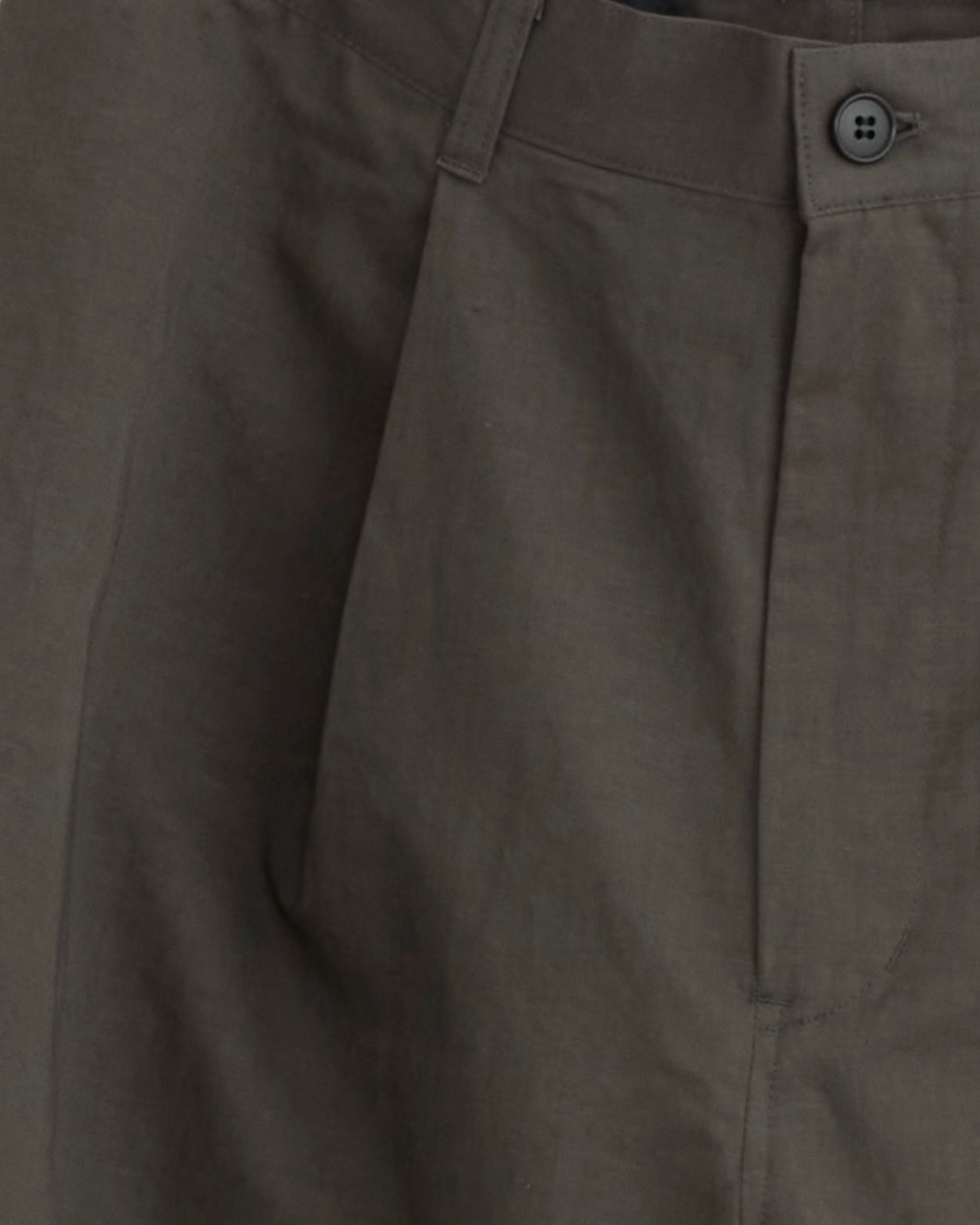 Close-up of the Linen Mixed Wide Short in Charcoal by Still By Hand, made in Japan, highlighting the waistband, button, belt loop, and front pocket. The smooth fabric has a slightly wrinkled texture.