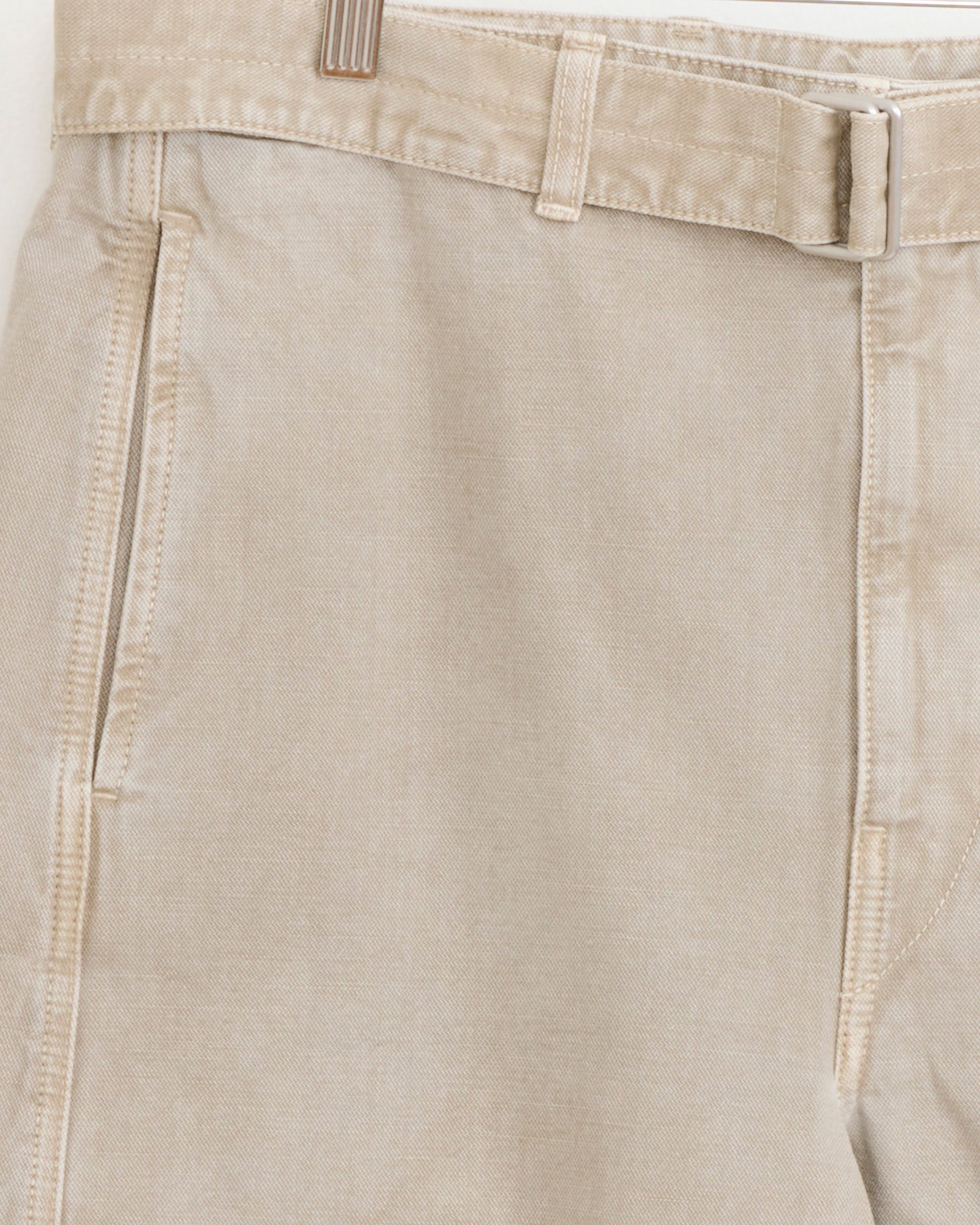 Close-up of the Lemaire Denim Short in Moonstone, highlighting the Bermuda silhouette with visible side pocket, belt loop, and waistband details that showcase its textured fabric and fine stitching.