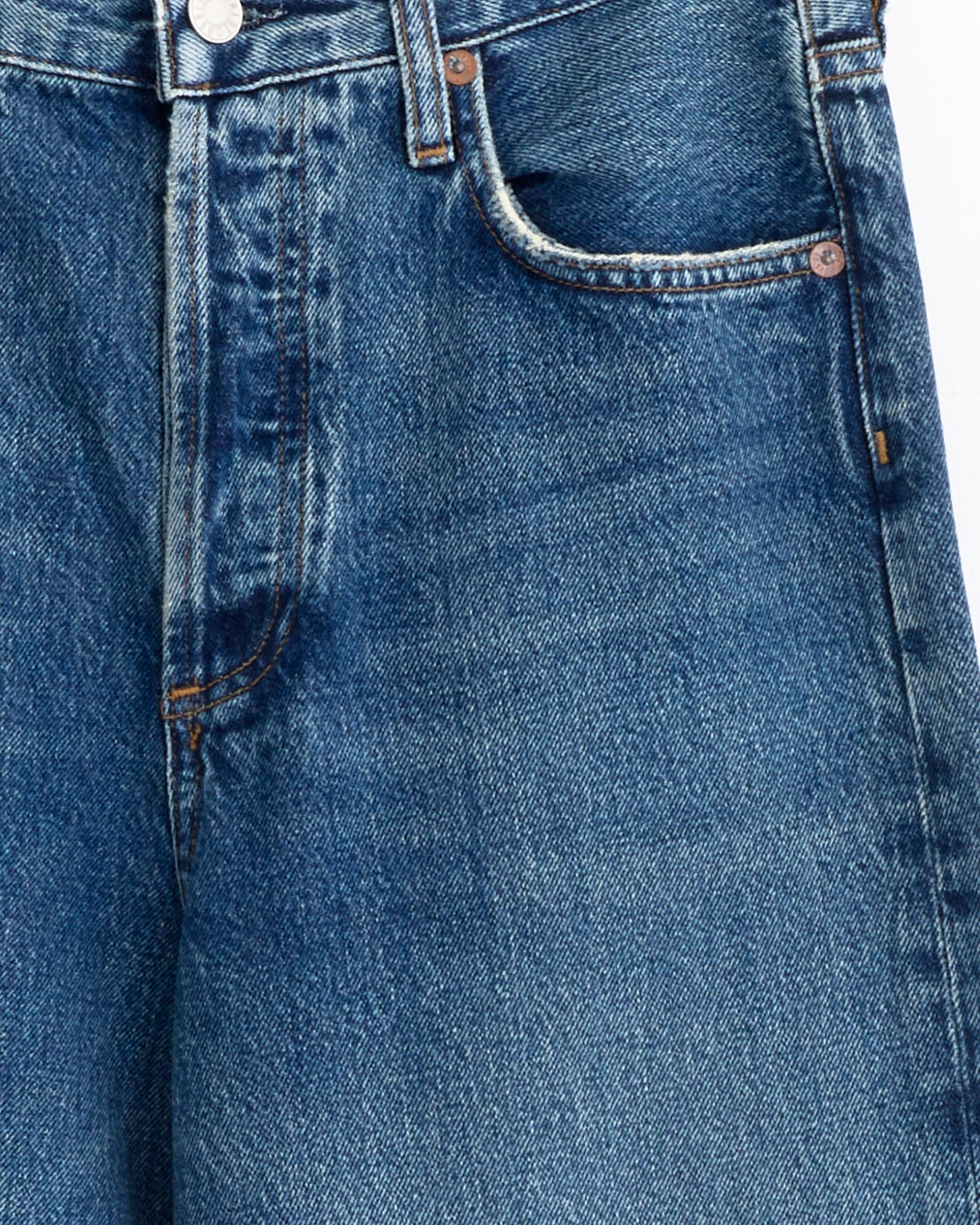 Close-up of AGOLDE’s Ren Jean 32" in Chapter shows the waistband, button, front pocket, zipper area with visible stitching and faded texture—ideal for checking fit and sizing before purchasing.