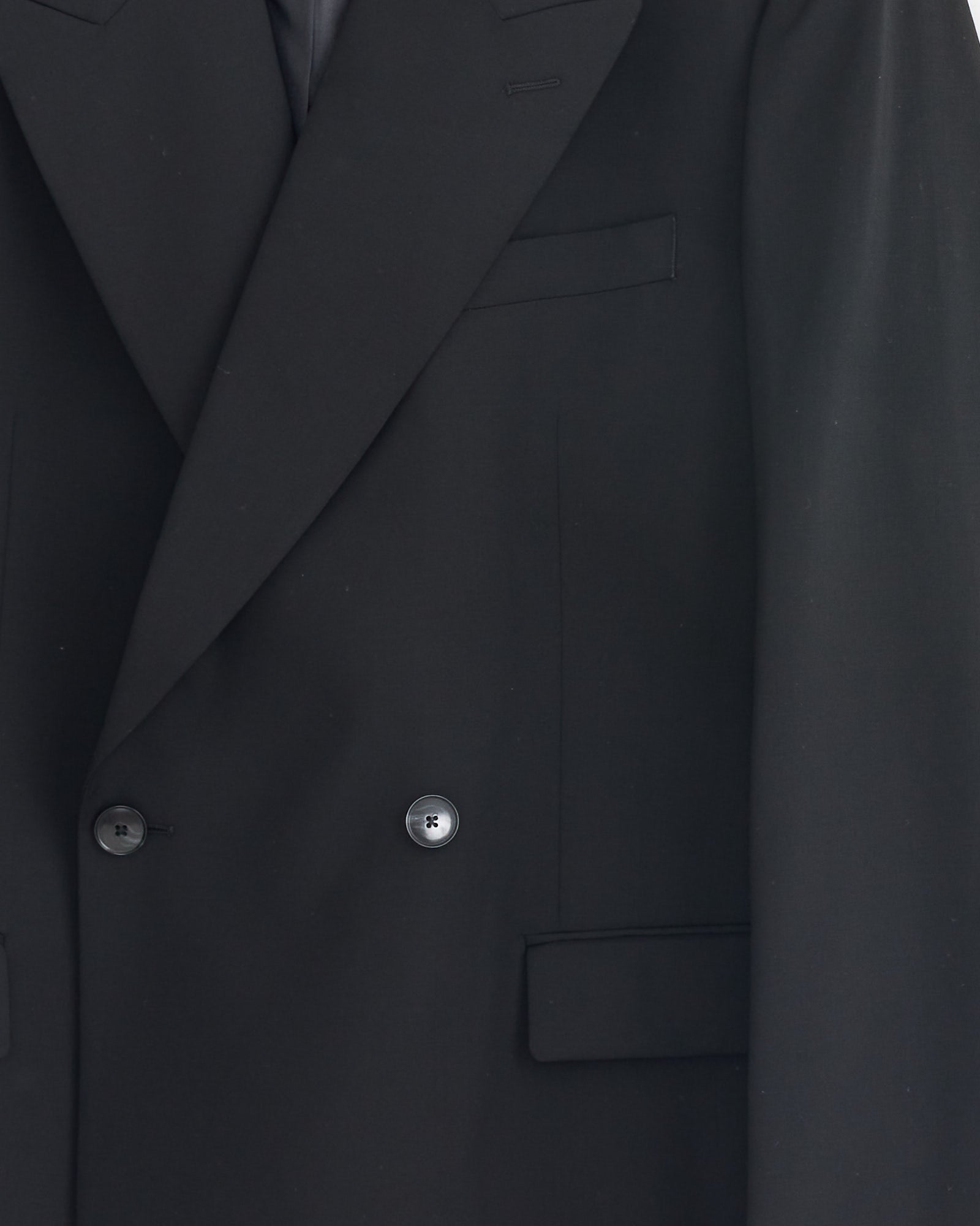Close-up of the mfpen Double Breasted Blazer in Black, crafted from fine Italian wool with a notched lapel, two-button front, and flap pocket.
