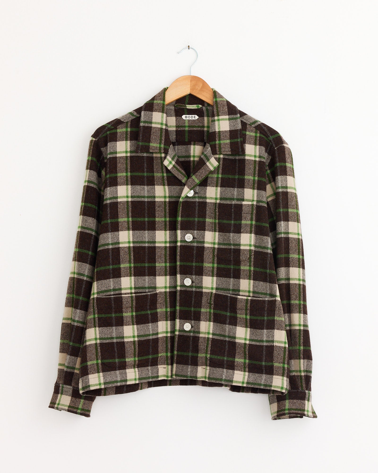 The model is wearing the Bode Woodcrest Overshirt in Brown/Green.