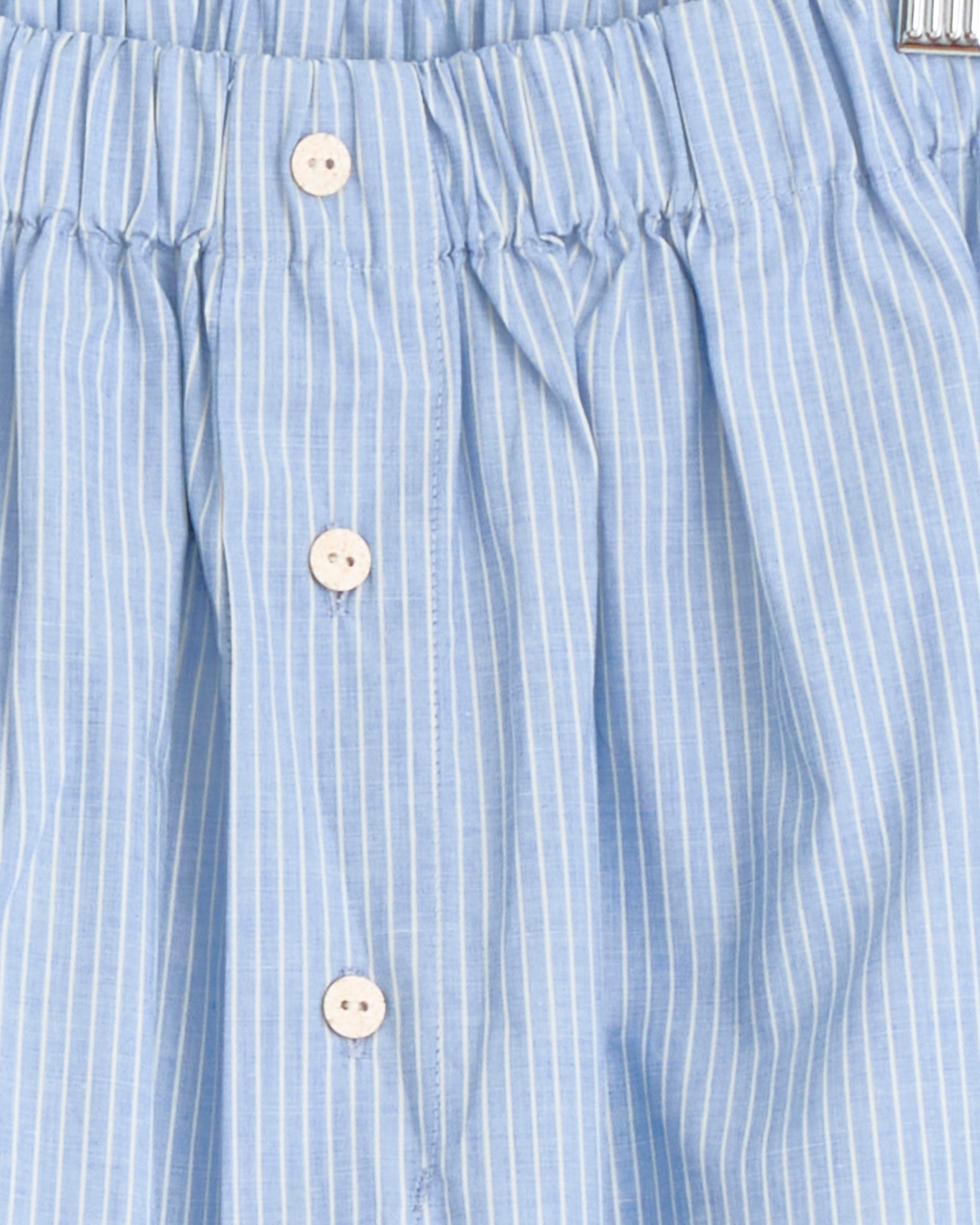 Close-up of Baserange Keep Short in Blue Stripe, made from lightweight organic cotton poplin with thin white stripes, an elastic waistband, central white buttons, and gentle gathering at the top for a relaxed fit.