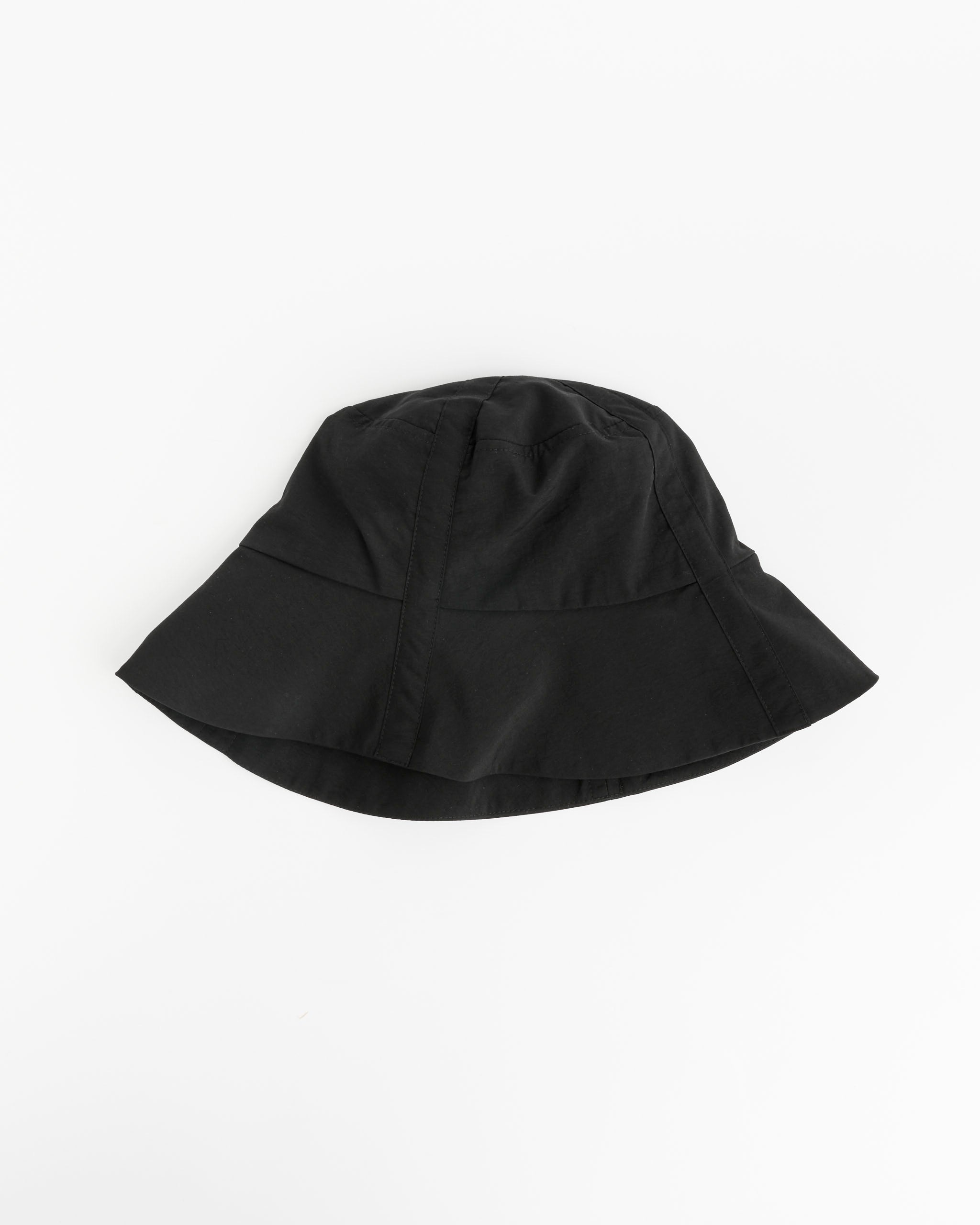 The Clyde Swim Bucket Hat in Black, crafted from water-resistant nylon, is shown against a white background. It features a wide, downward-sloping brim and minimalistic stitching for a sleek look.