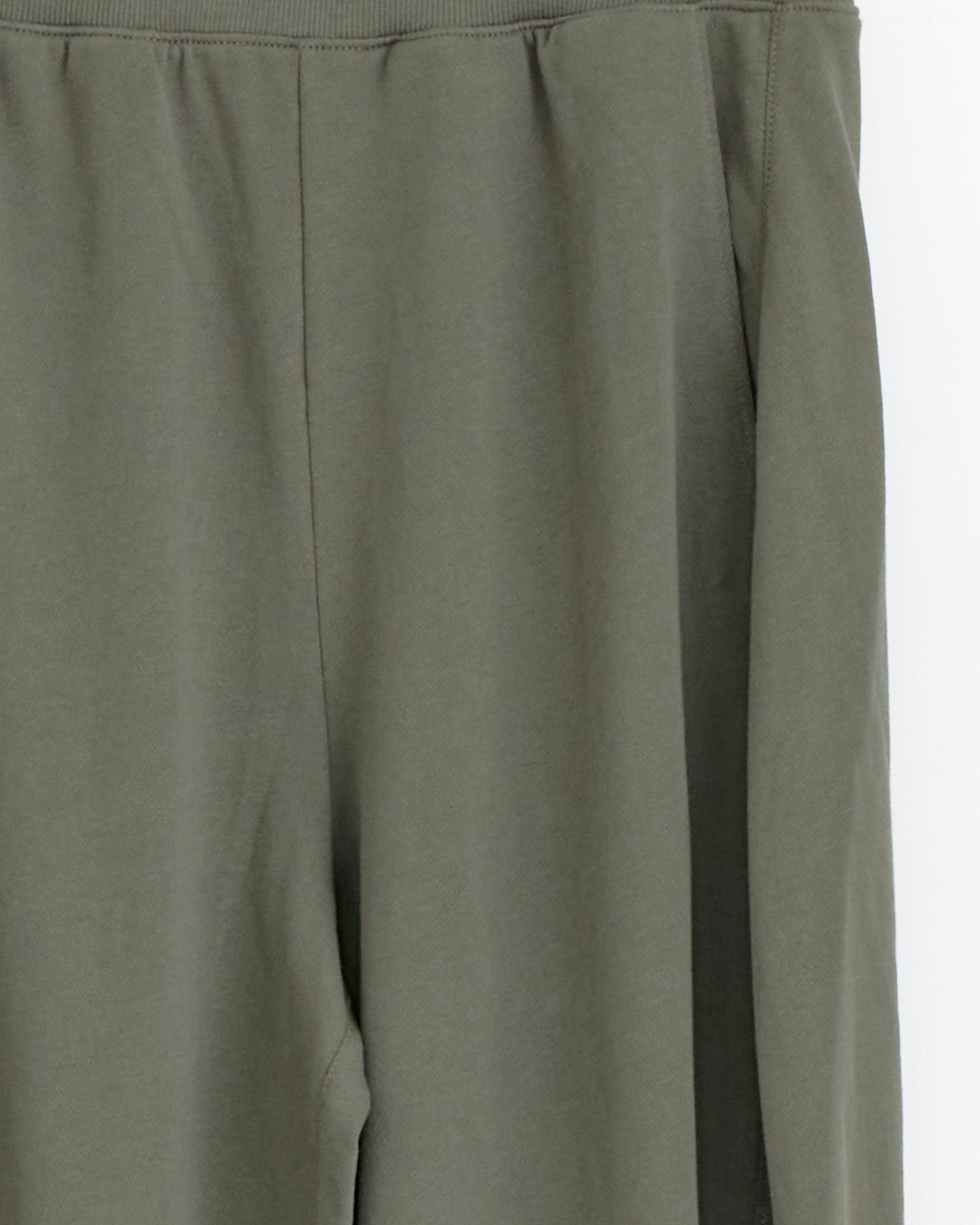 Close-up of Tibi Light Weight Winslow Pant in Olive, crafted from soft, lightweight cotton. Features a relaxed fit with a smooth waistband and upper leg—no visible buttons, zippers, or pockets.