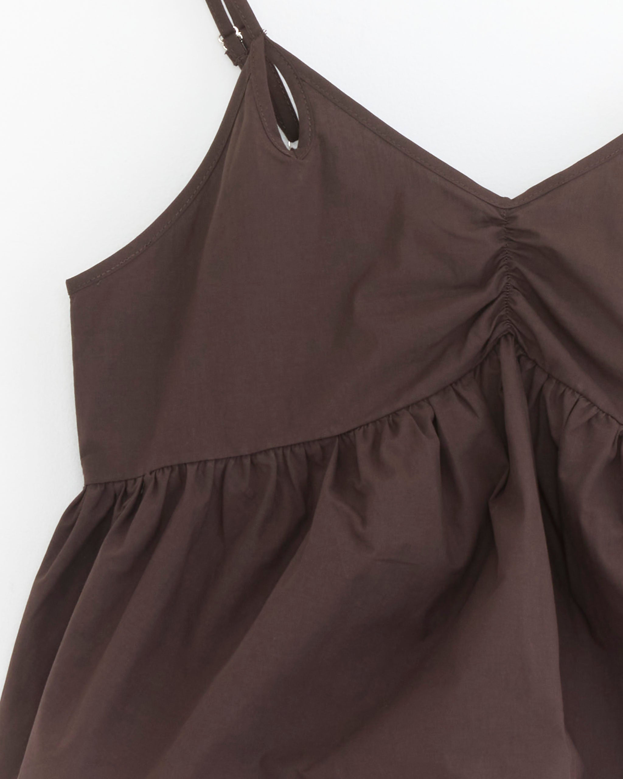 Close-up of the Bind Set in Sepia by Deiji Studios, featuring a brown sleeveless cami with thin straps, gathered bust, and flared ruched detail—ideal for pairing with boxer shorts for a relaxed Deiji Studios-inspired look.