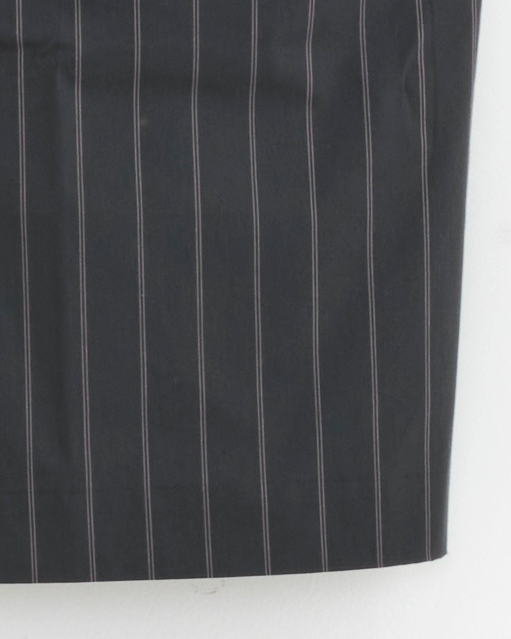 Close-up of ST. AGNI’s Strapless Rouleau Tie Top in Ink Stripe, featuring vertical white pinstripes, shown against a plain white background.