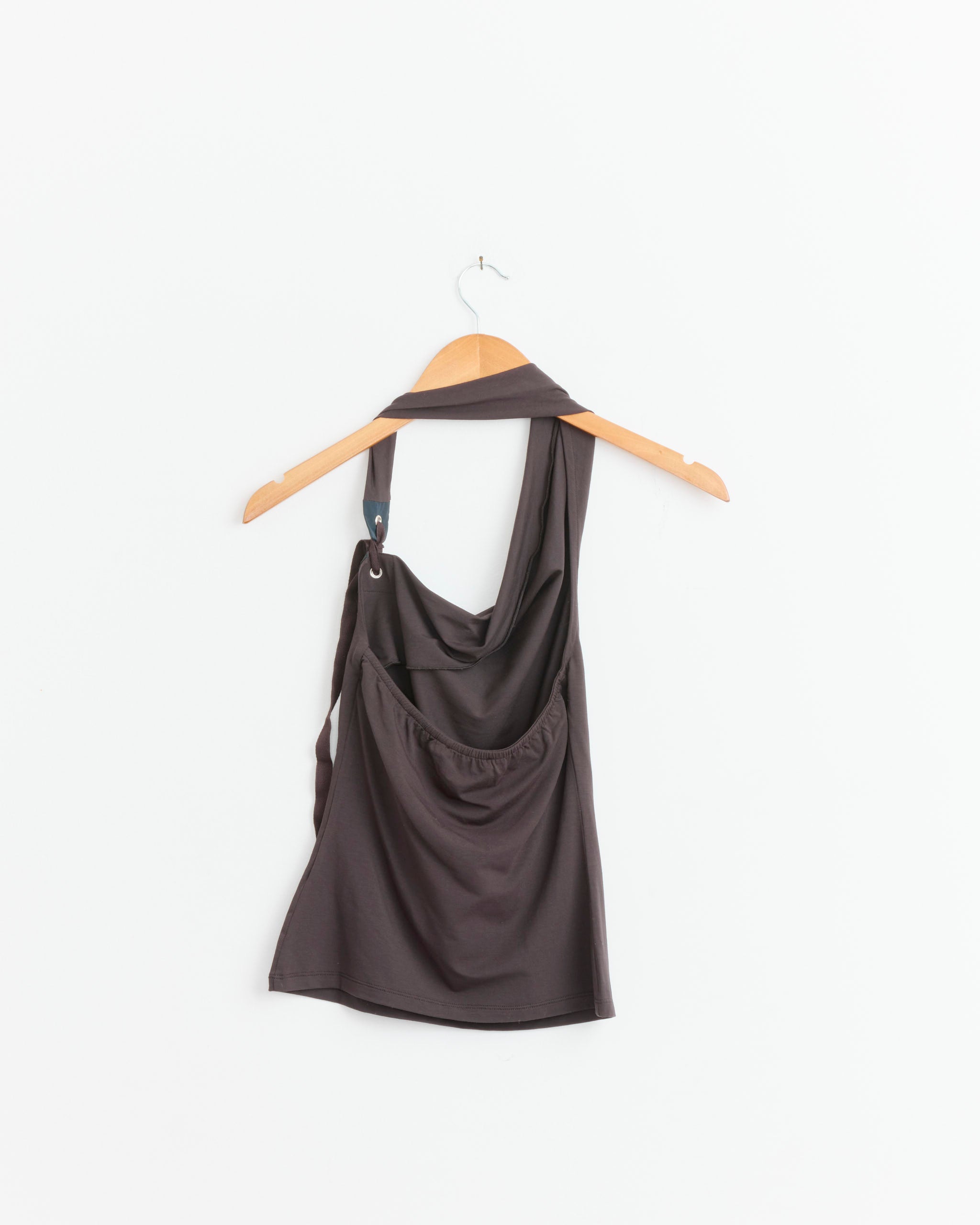 A brown Paloma Wool Simulet Top with a draped neckline is displayed on a wooden hanger against a plain white background.