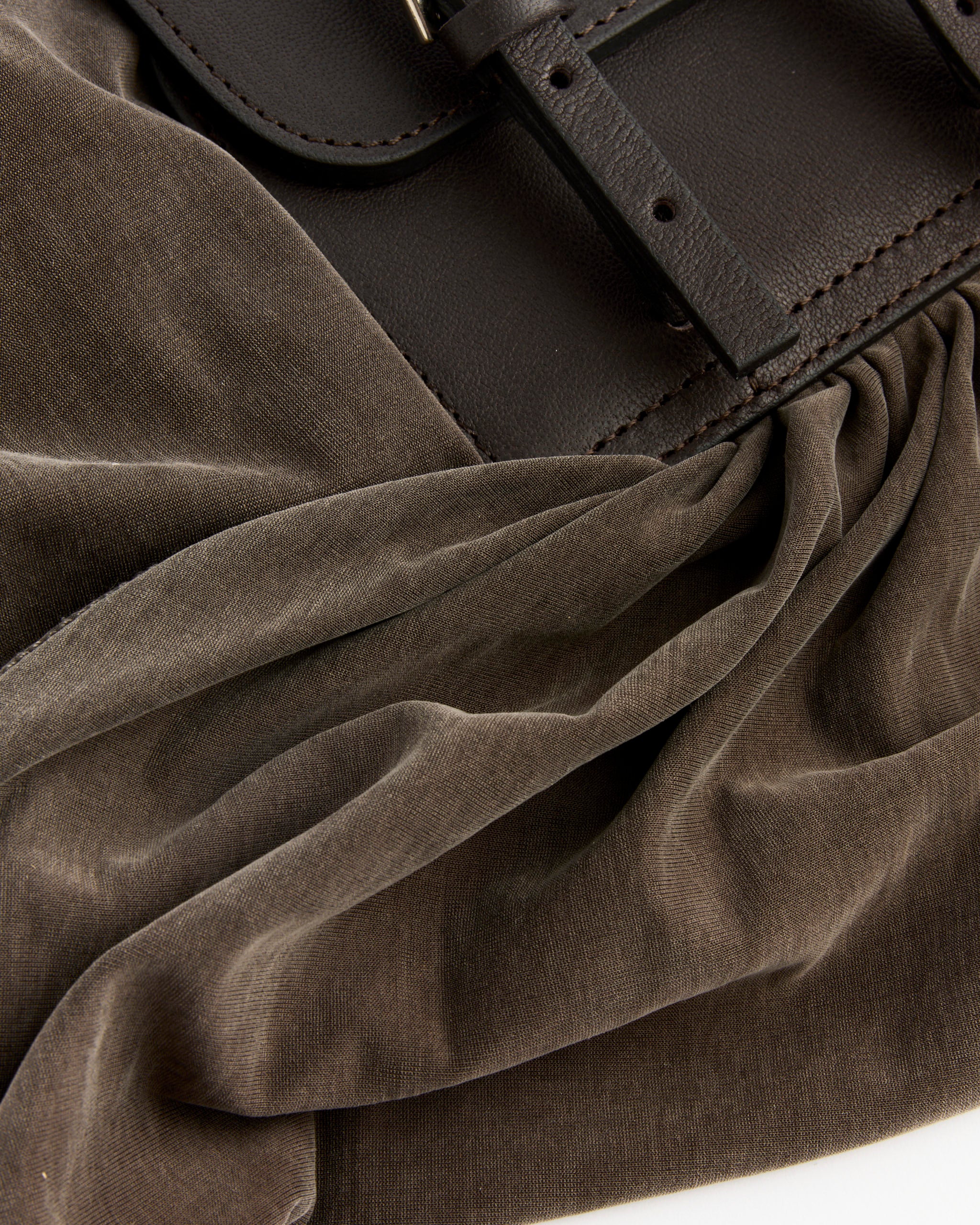 Close-up of the Paloma Wool Adriana II Belt in Multi, featuring a double buckle detail, styled with soft, ruched brown velvet fabric.