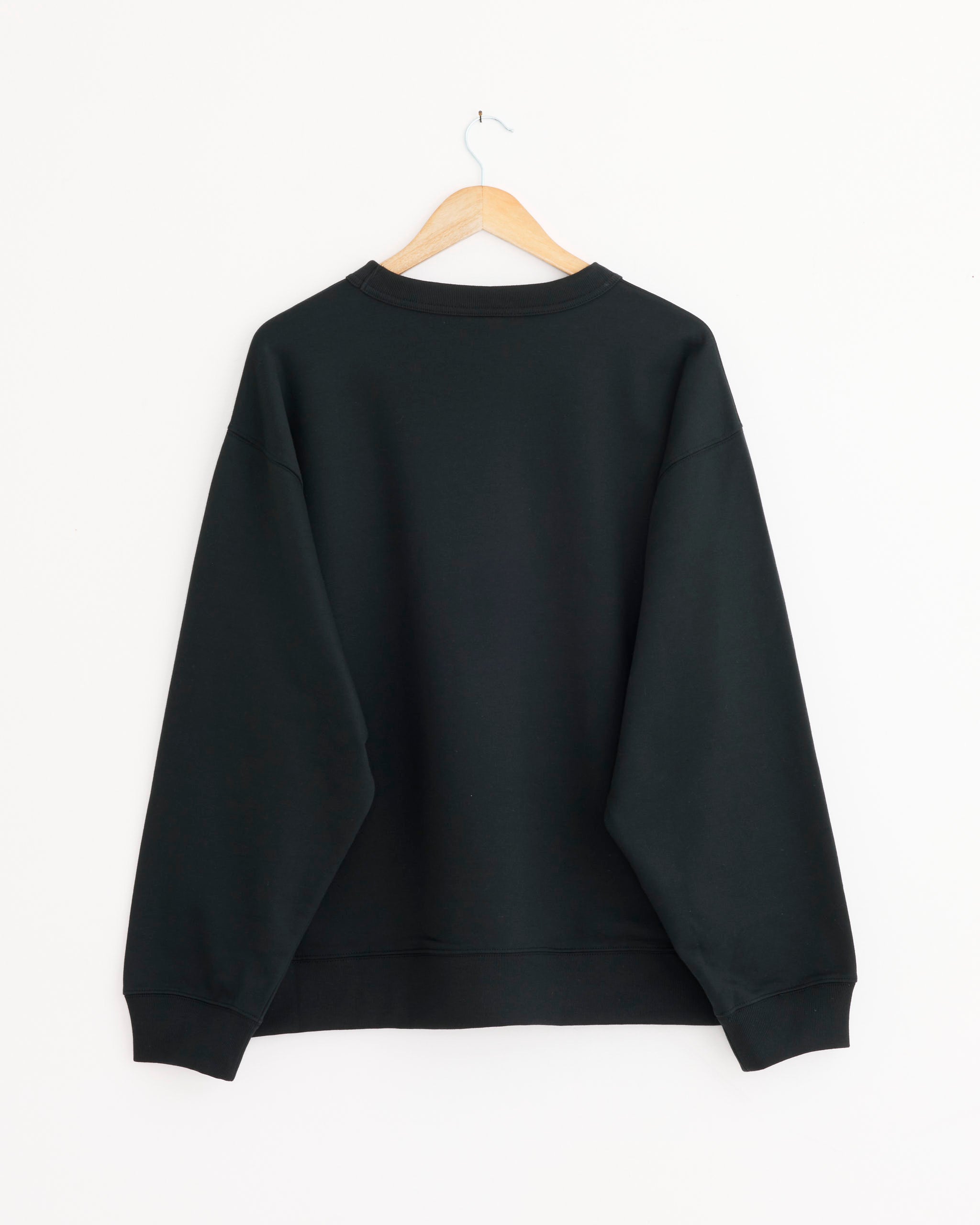 The Dries Van Noten Crewneck Hax Sweatshirt in anthracite loopback cotton-jersey hangs on a wooden hanger against a white background, displayed from the back.
