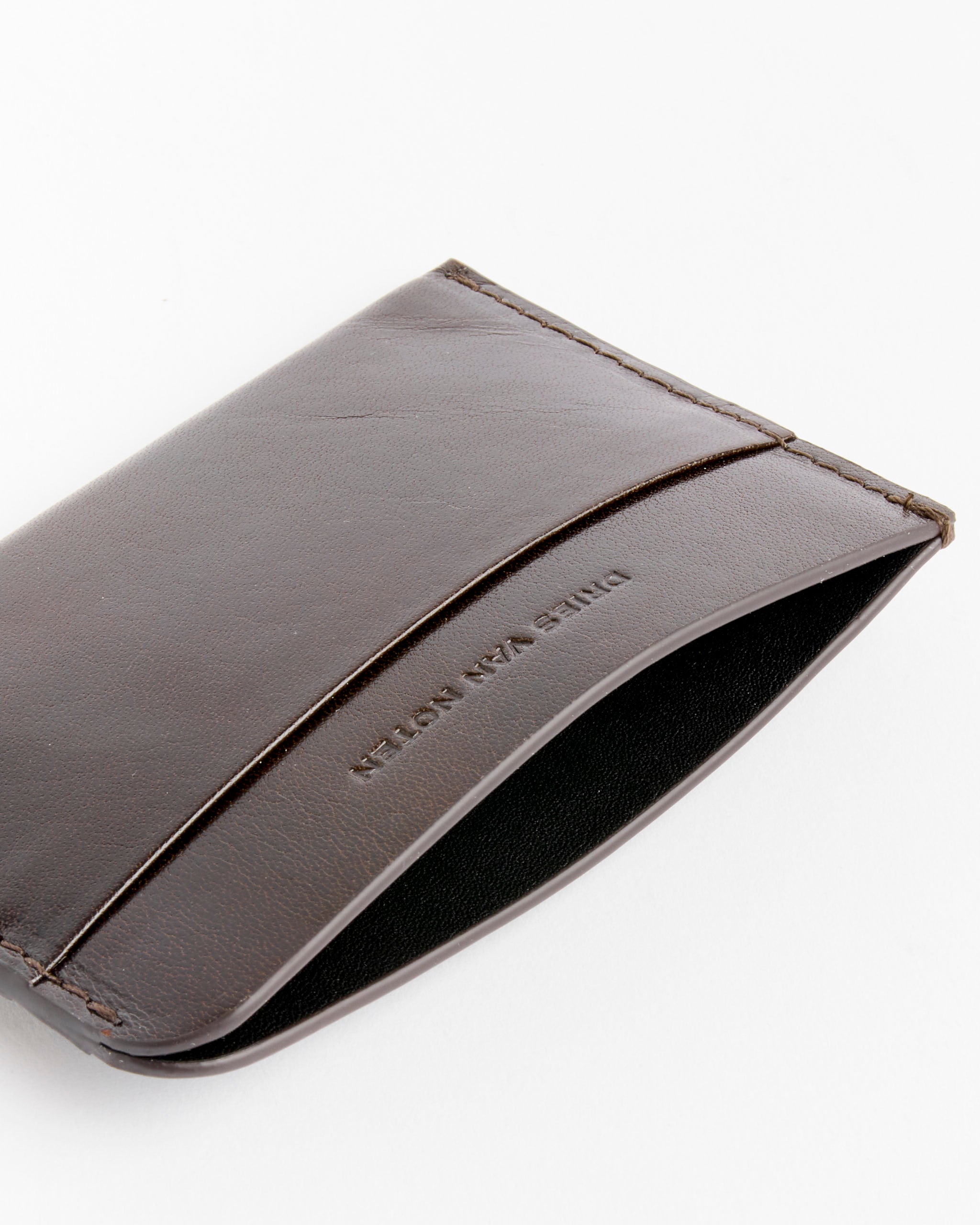 A minimalist Cardholder in Dark Grey by Dries Van Noten, featuring an open pocket and embossed text, displayed on a white background.