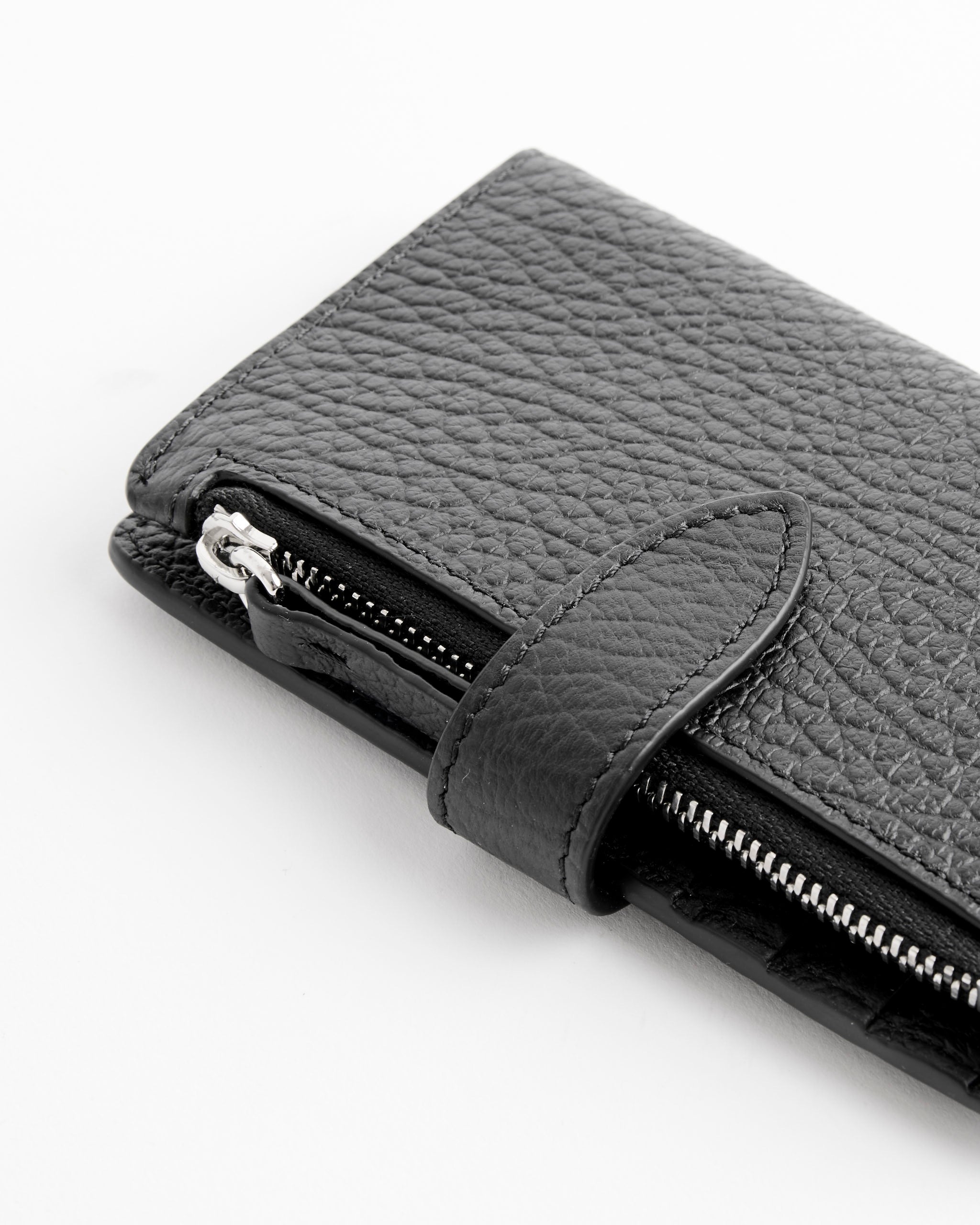 Close-up of the Maison Margiela Card Holder Clip 2 With Zip in Black, featuring textured leather, a strap, and visible silver zipper details, shown against a white background.