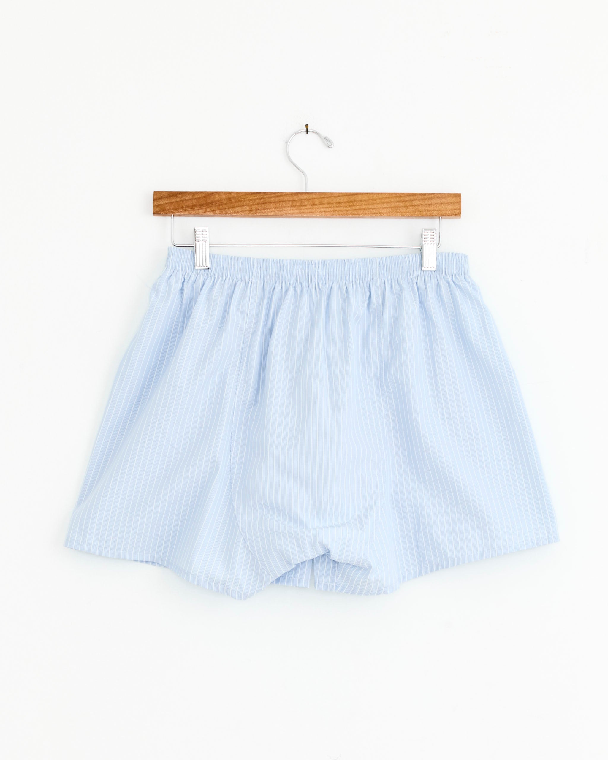 Salon C. Lundman Boxer in Multi—light blue striped men's boxer shorts, made from 100% cotton in Portugal—shown on a wooden hanger against a plain white background. Available at Mohawk General Store.