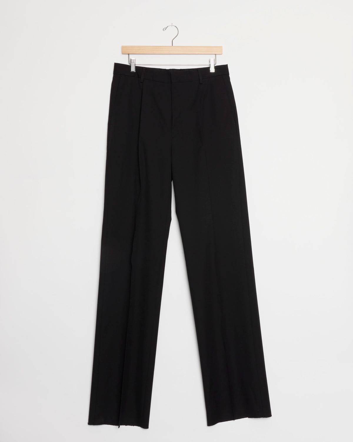 Black straight-leg dress pants from the Dries Van Noten Cotton-Wool Suit in Black, displayed on a wooden hanger against a plain white background.