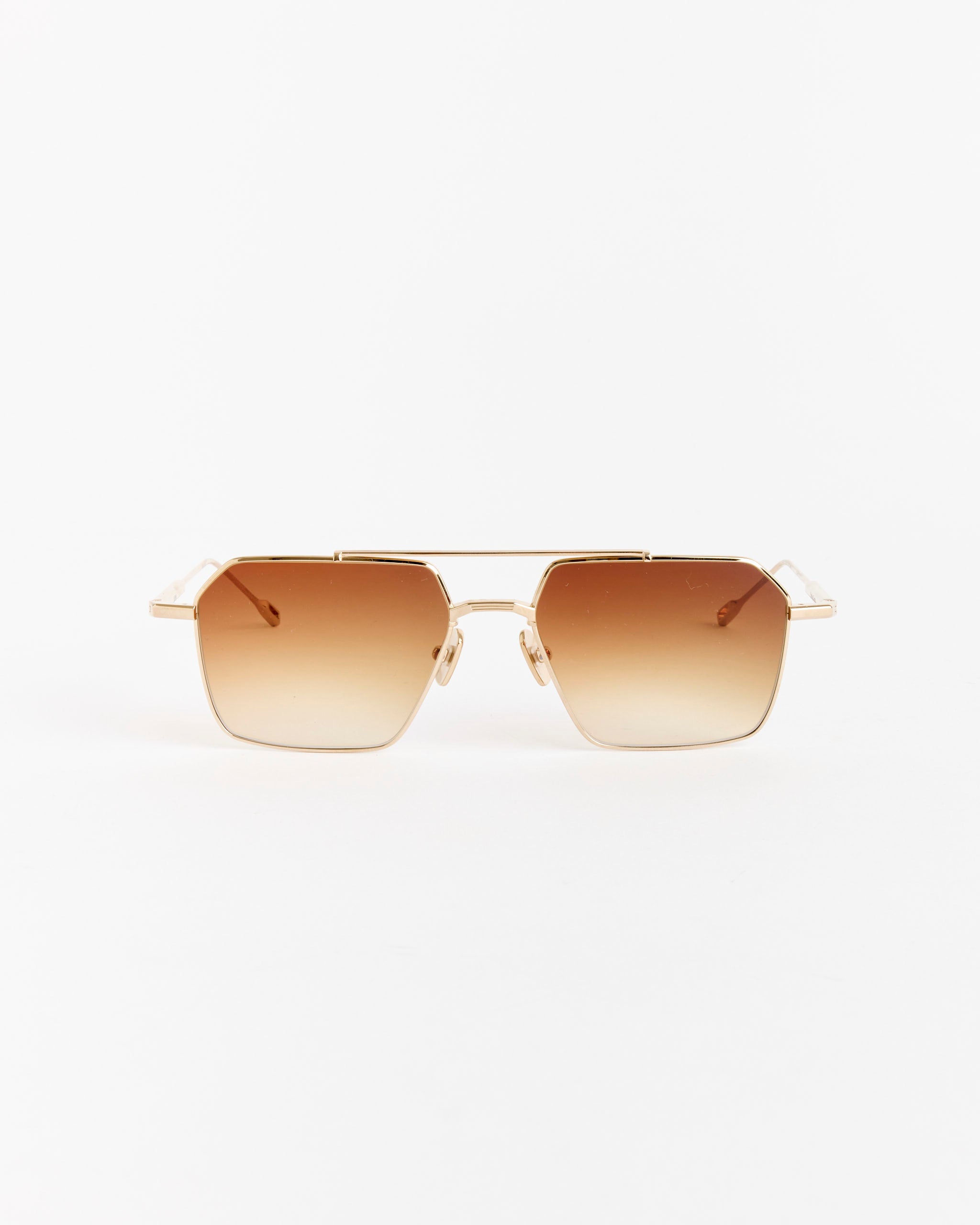 The Native Sons Remm 55 Sunglasses feature 16K gold metal frames and rectangular spice brown gradient lenses, shown on a white background—perfect for any fit. Need sizing help? Chat with us online anytime.