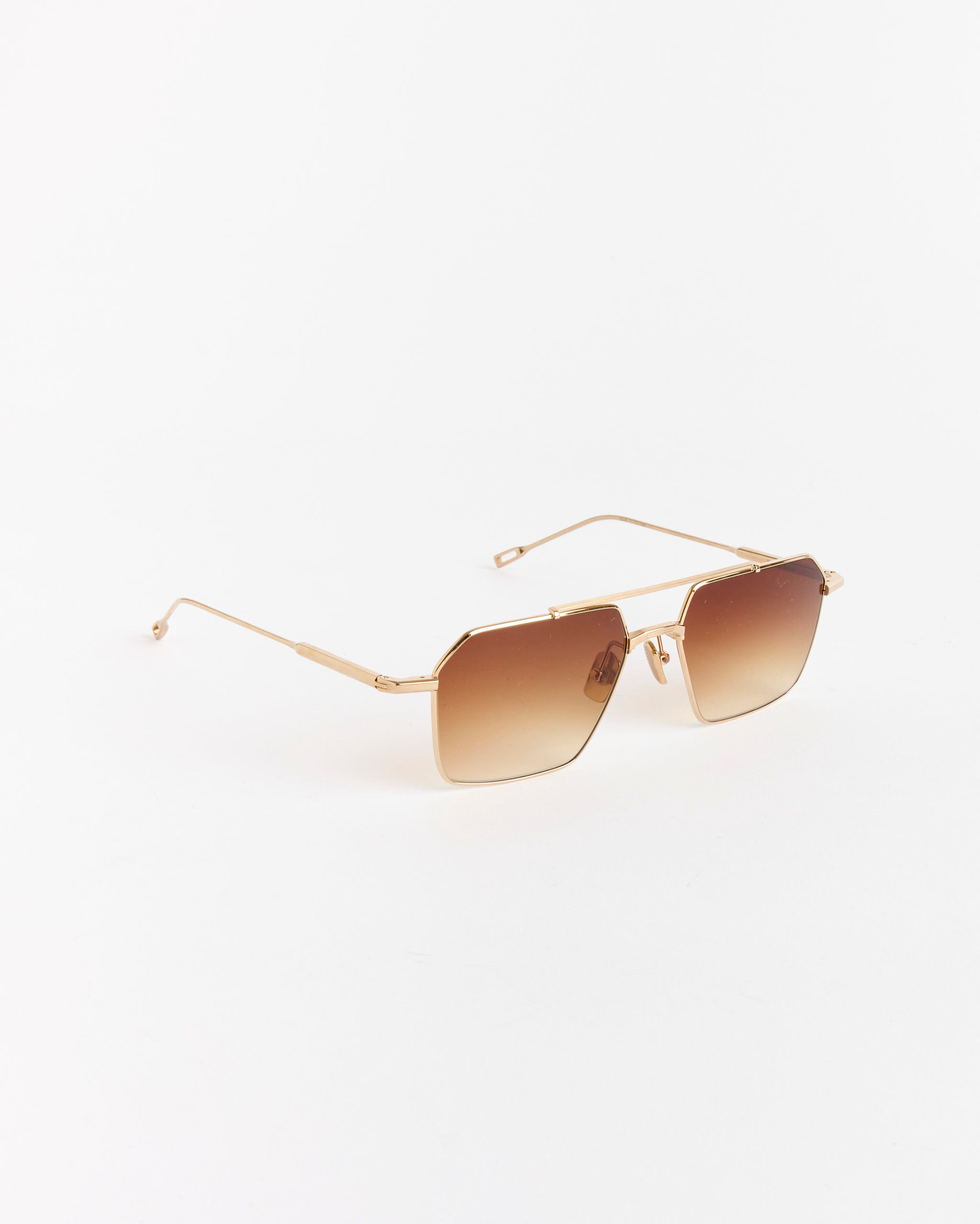 The Remm 55 Sunglasses by Native Sons feature 16K gold geometric frames and spice brown gradient AR-coated lenses. Displayed on a white background—connect with our online chat for sizing or fit questions.