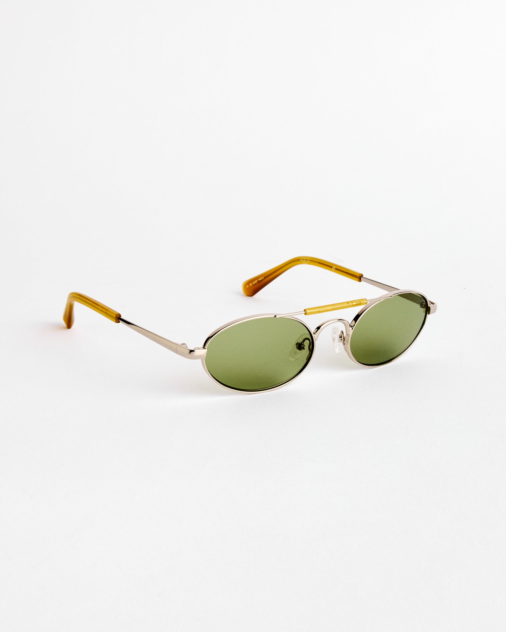 Dries Van Noten’s Sunglasses in Silver/Ocra/Green C2 feature oval green lenses, silver metal frames, and yellow temple tips, displayed against a plain white background.