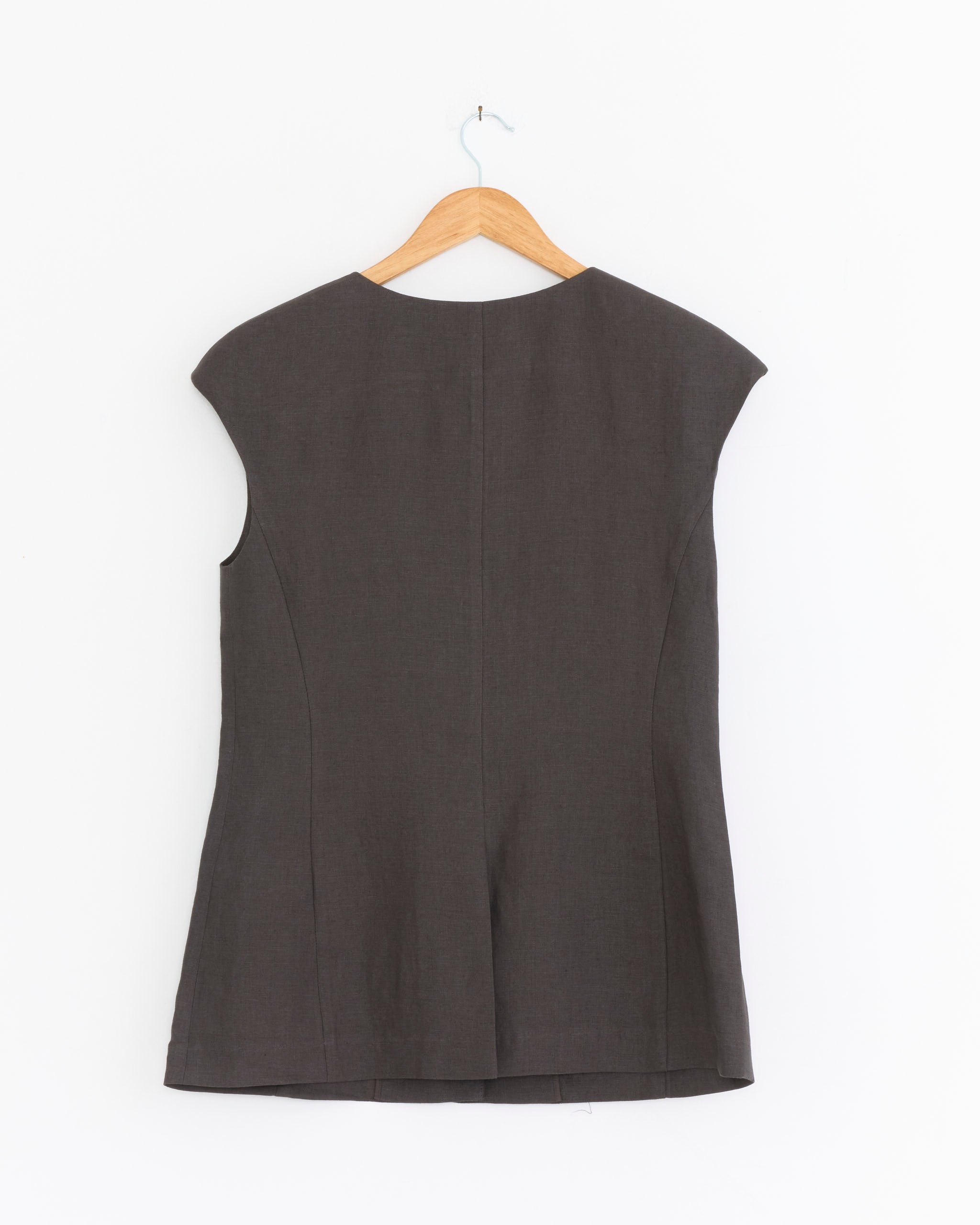 The Amomento Linen Curved Vest in Khaki Grey is displayed on a wooden hanger against a plain white background, shown from the back.