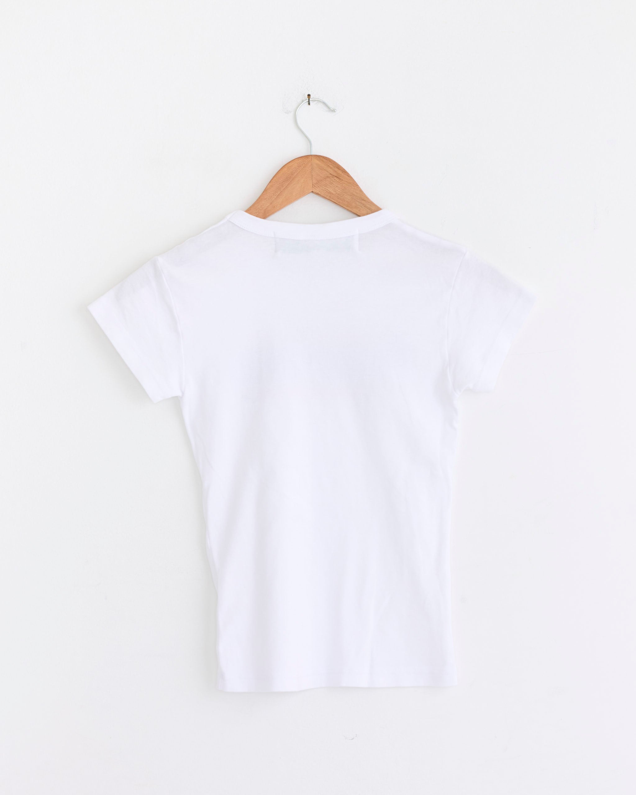 The Korea Tee in Multi by Made Some Sportswear hangs on a wooden hanger against a white wall, shown from the back.