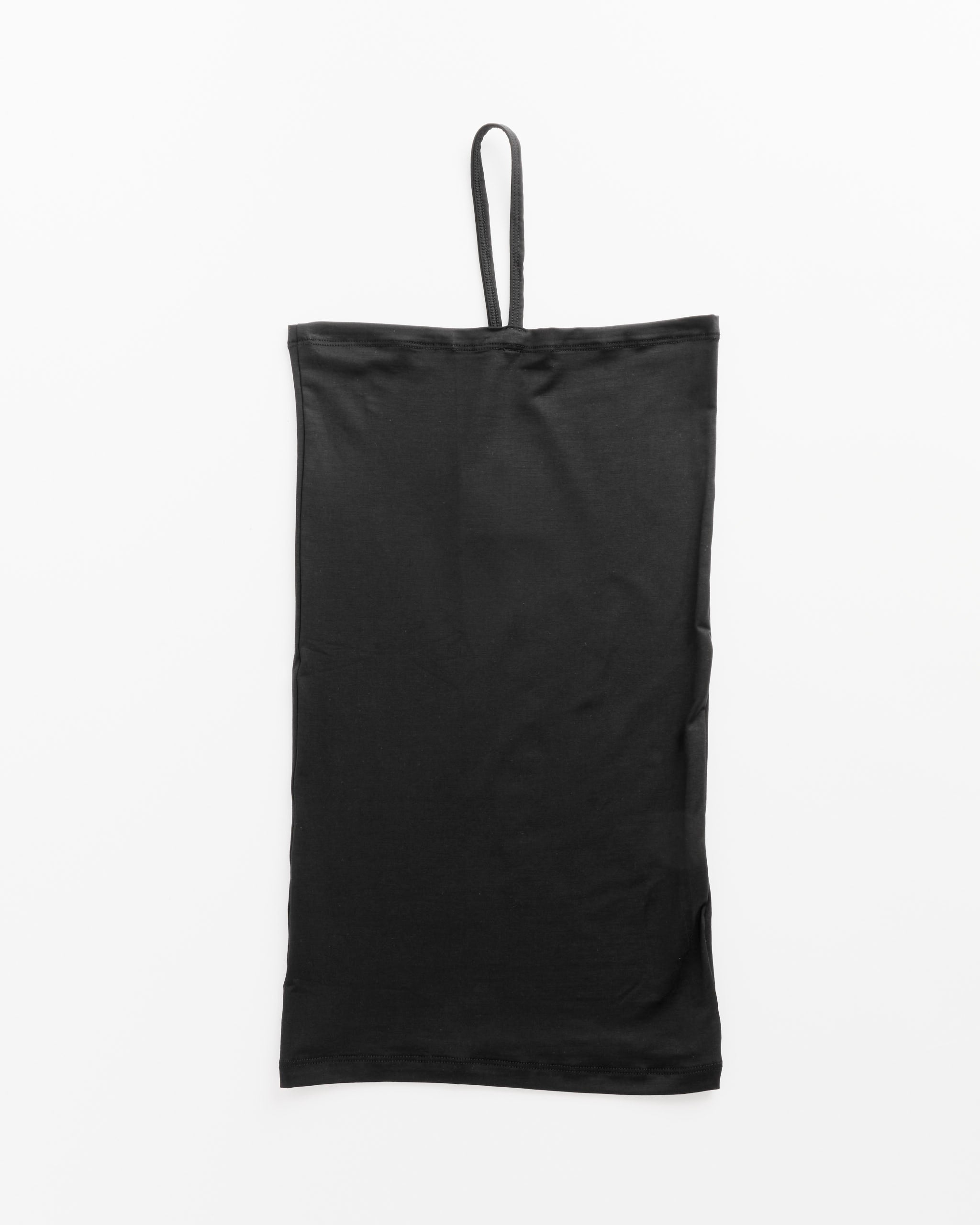 The Nida One Strap in Black by Baserange is a flat black garment crafted from bamboo lyocell and elastane, featuring a thin strap loop at the top and displayed on a white background.