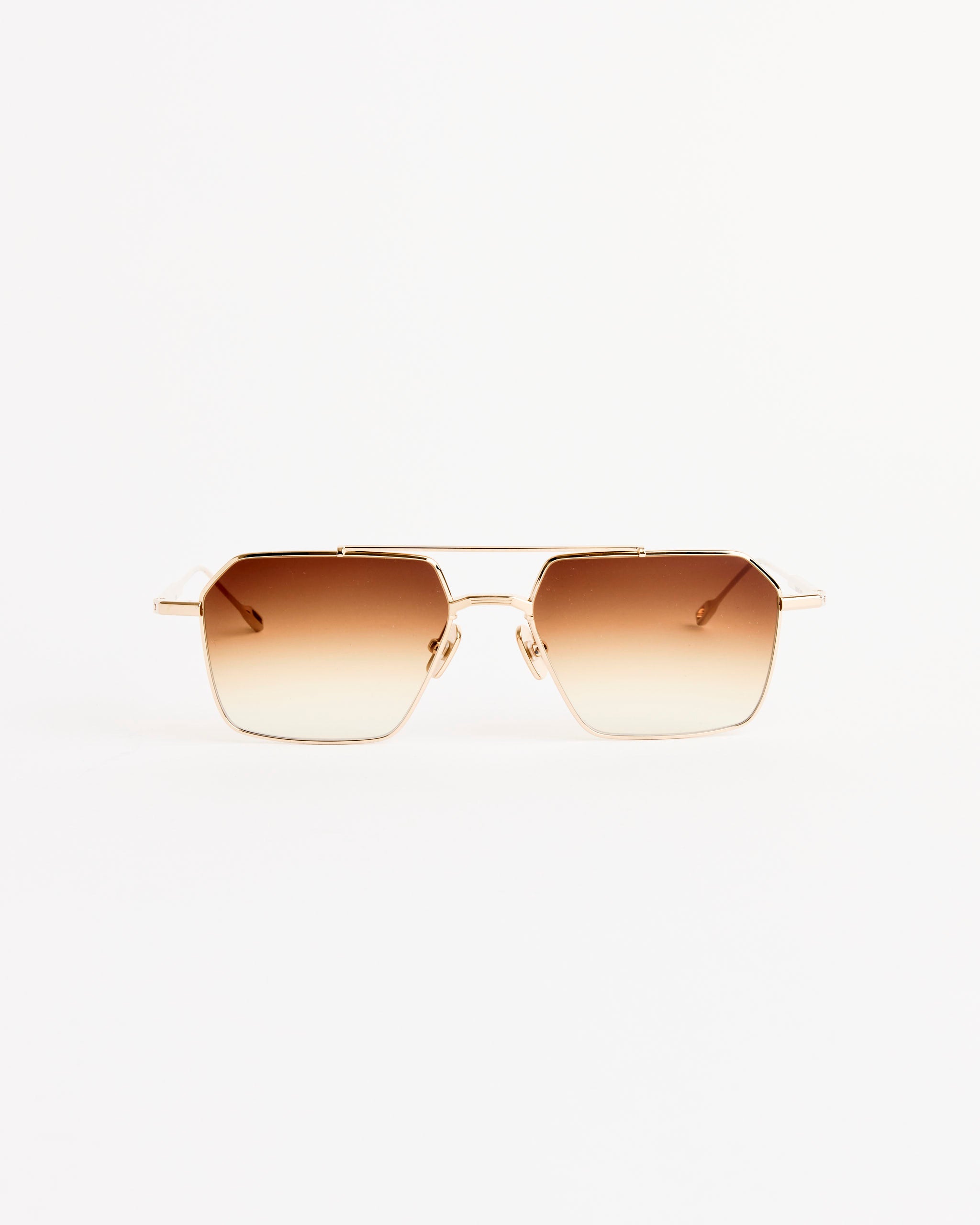 The Remm 55 Sunglasses by Native Sons feature geometric titanium frames in 16K gold with spice brown gradient UV protection lenses, shown against a plain white background.